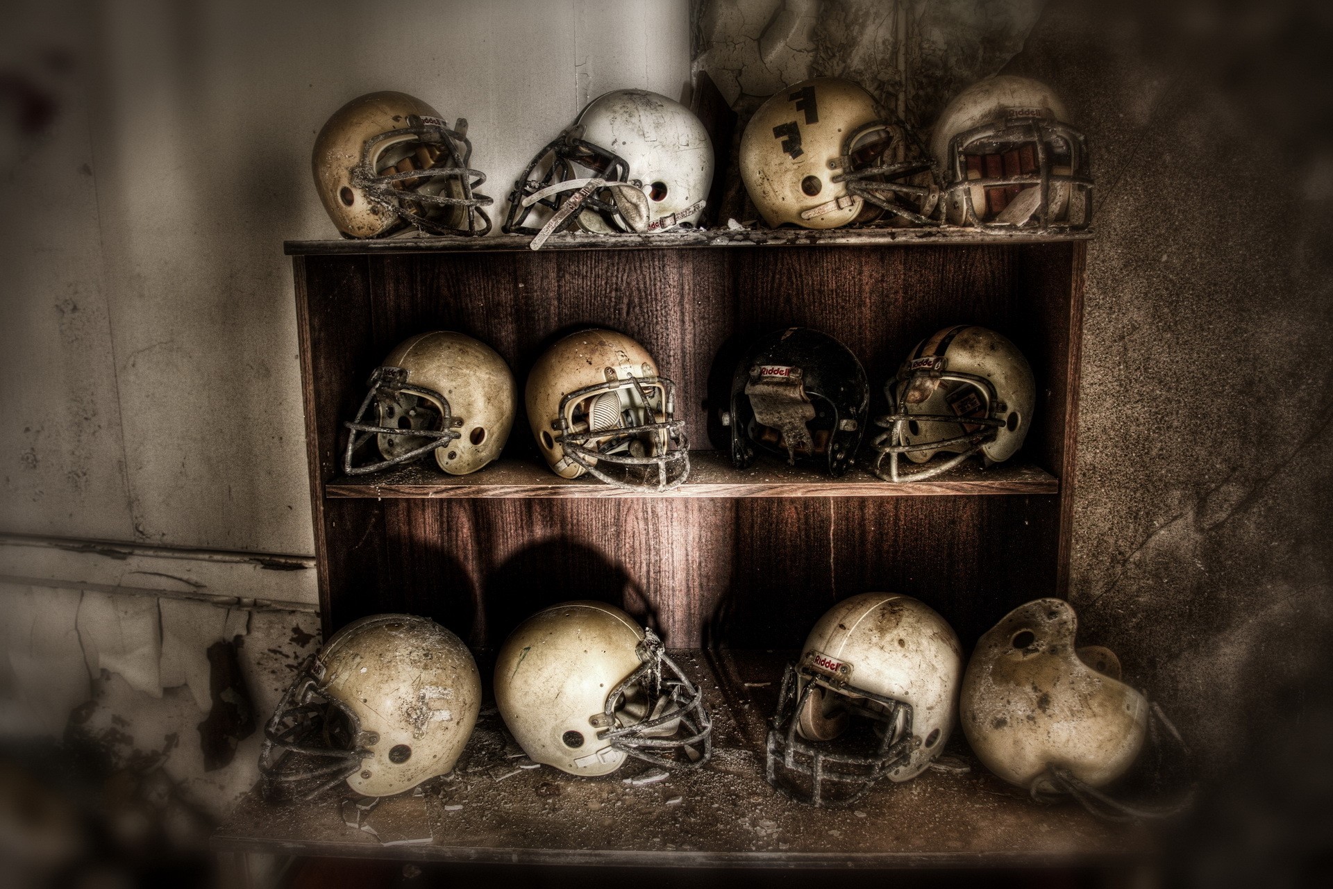 Collection of old American football helmets on shelves HD Wallpaper