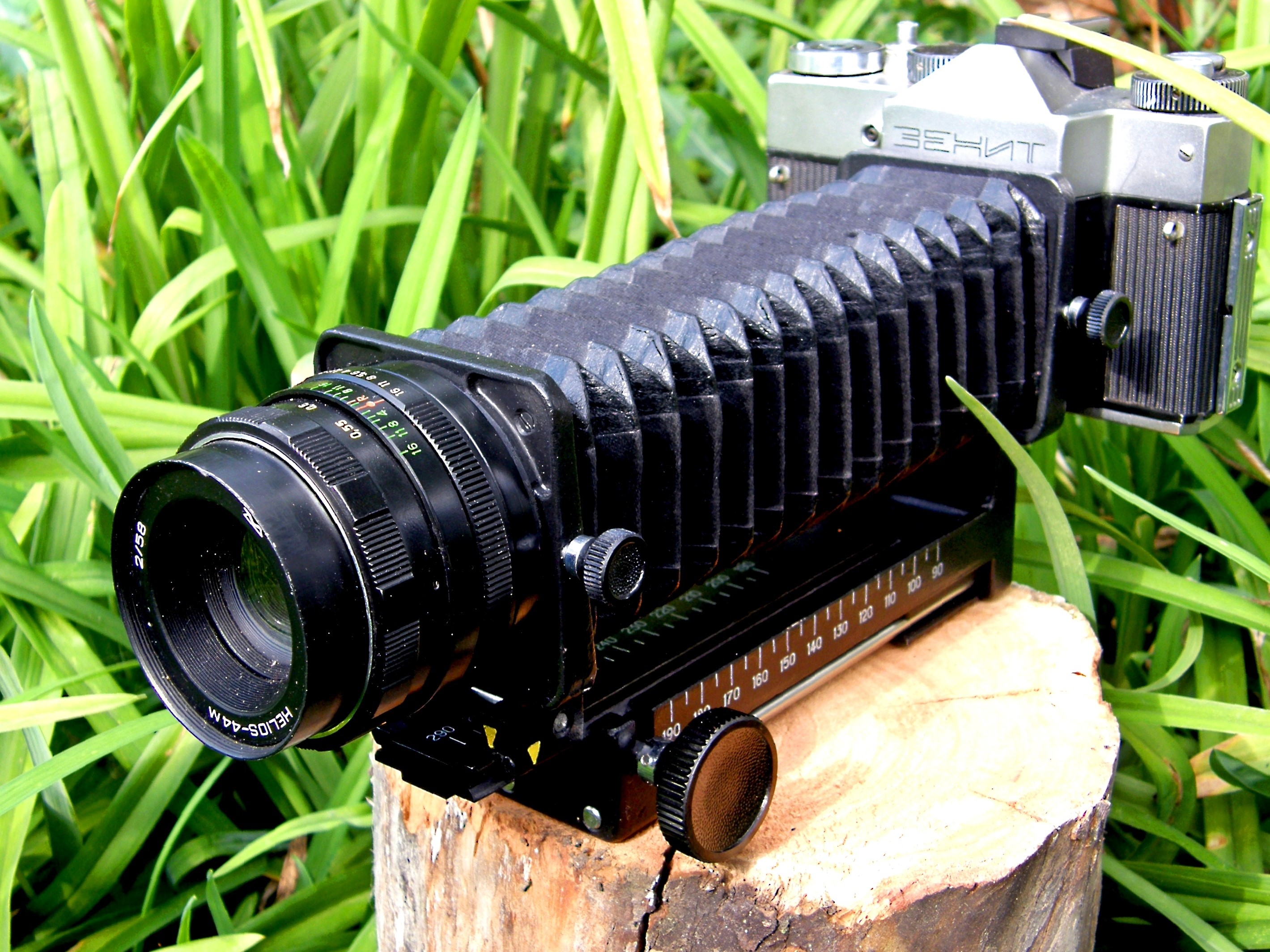 Zenit Helios-44M bellows camera on a log HD Wallpaper