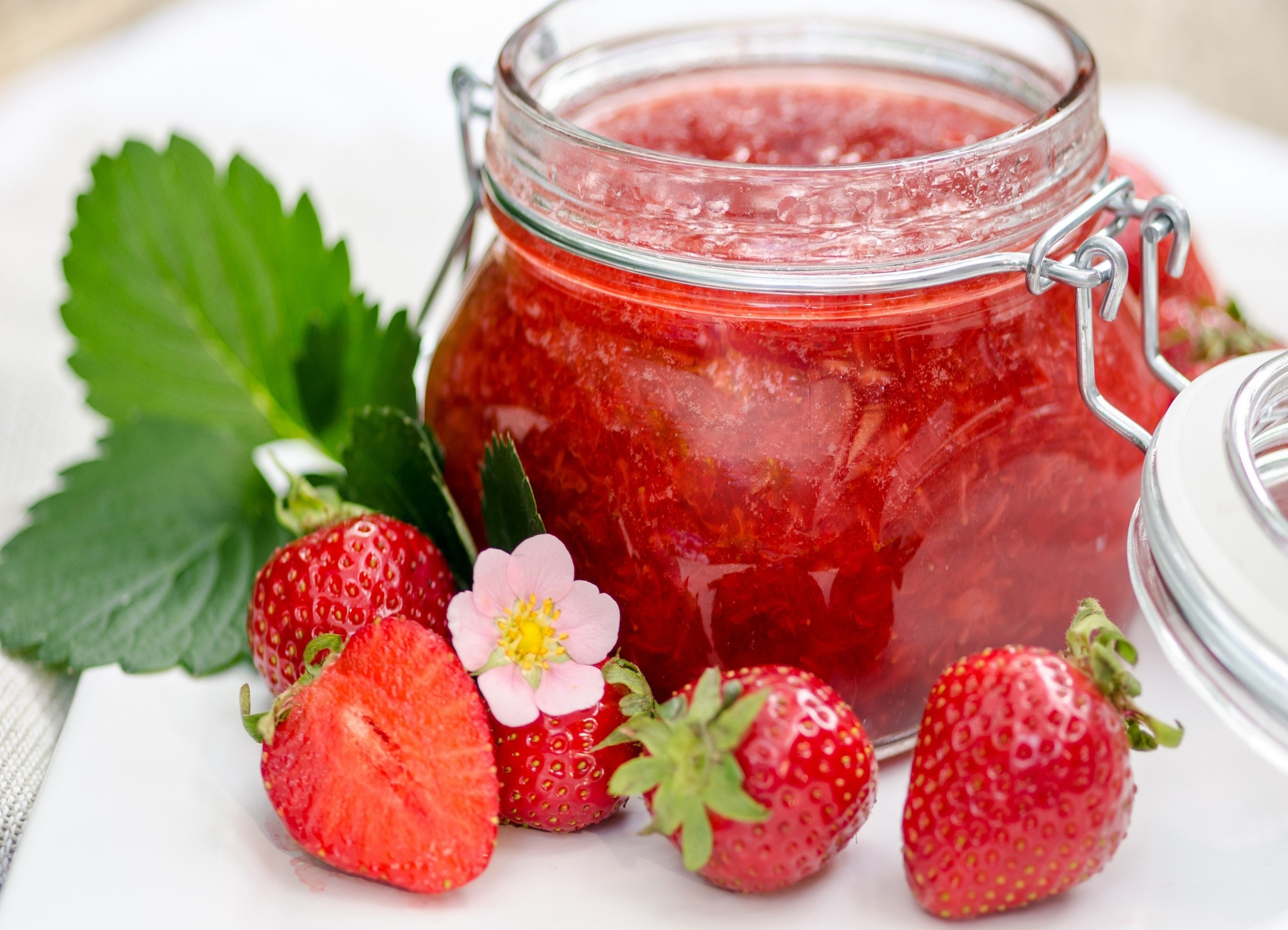Jar of strawberry jam with fresh strawberries HD Wallpaper