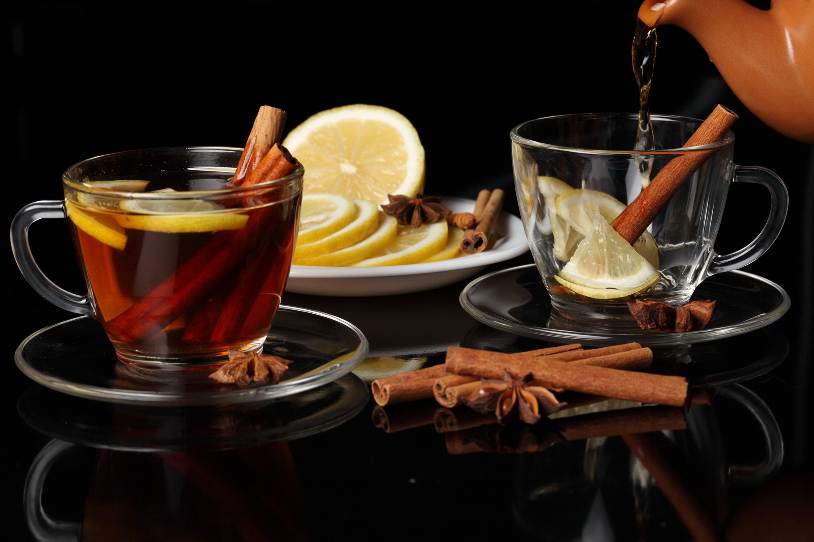 Tea with cinnamon and lemon in cups HD Wallpaper