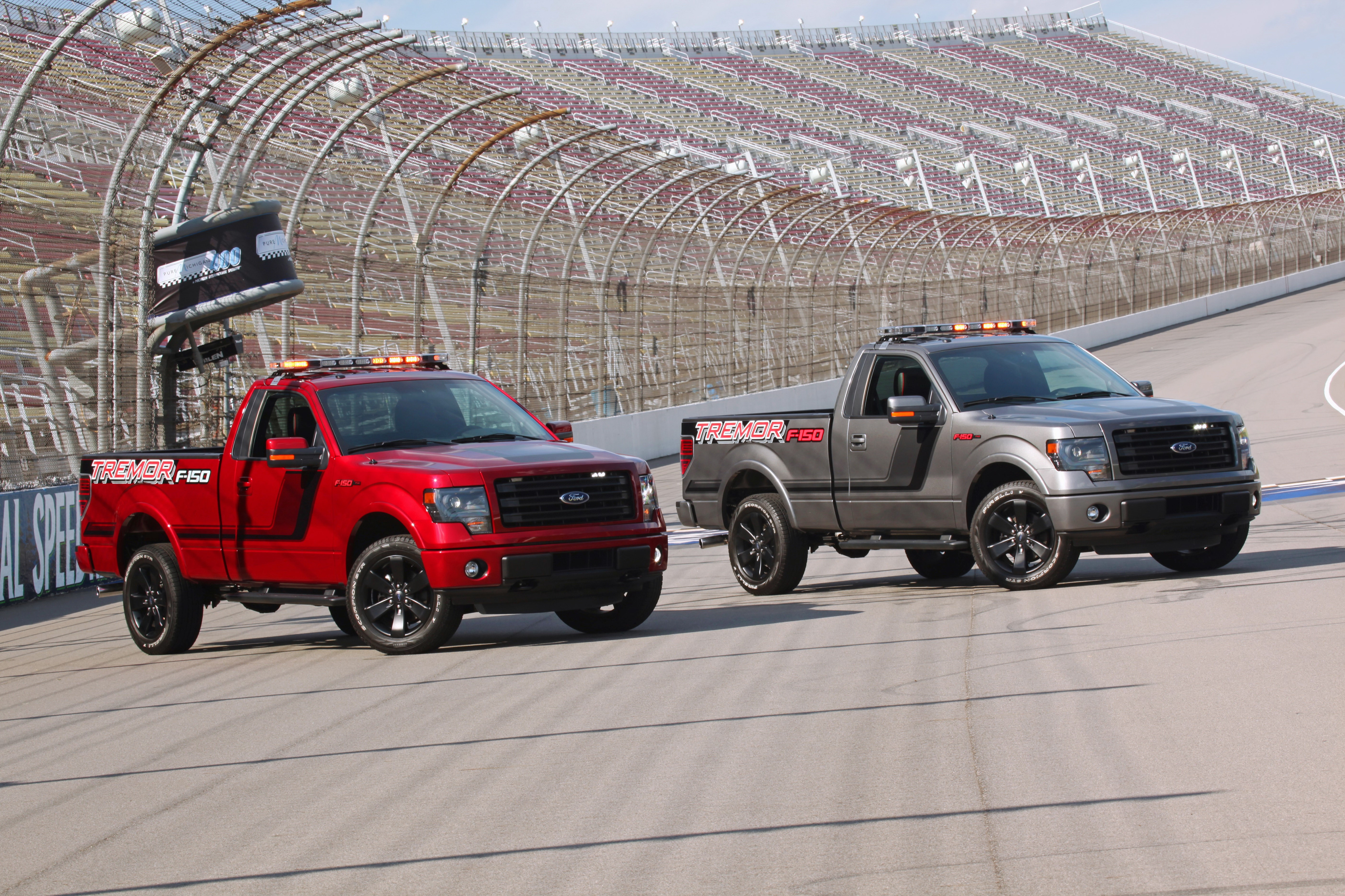 2014 Ford F-150 Tremor trucks on a racetrack HD Wallpaper