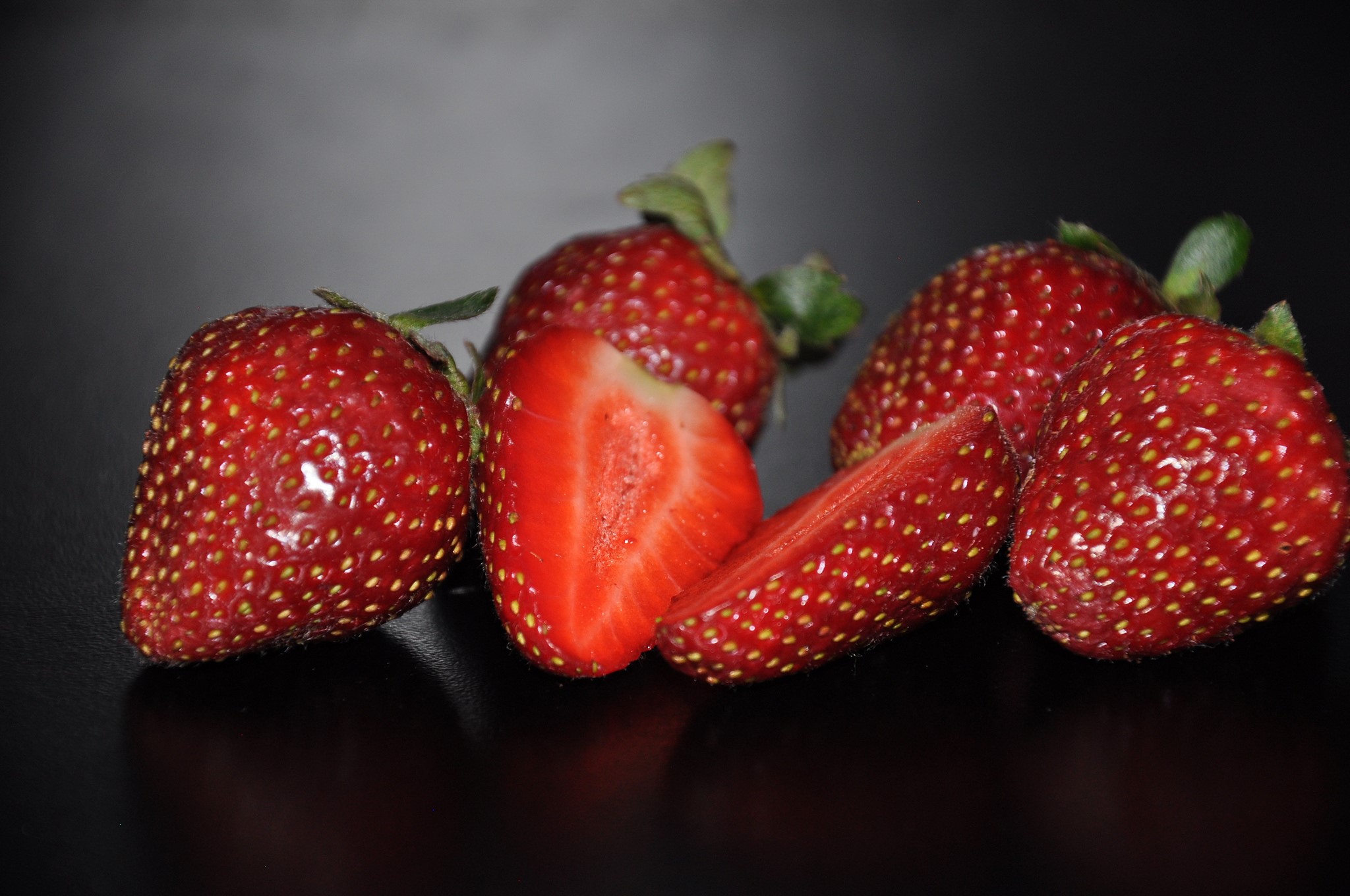 Strawberries on a dark surface HD Wallpaper