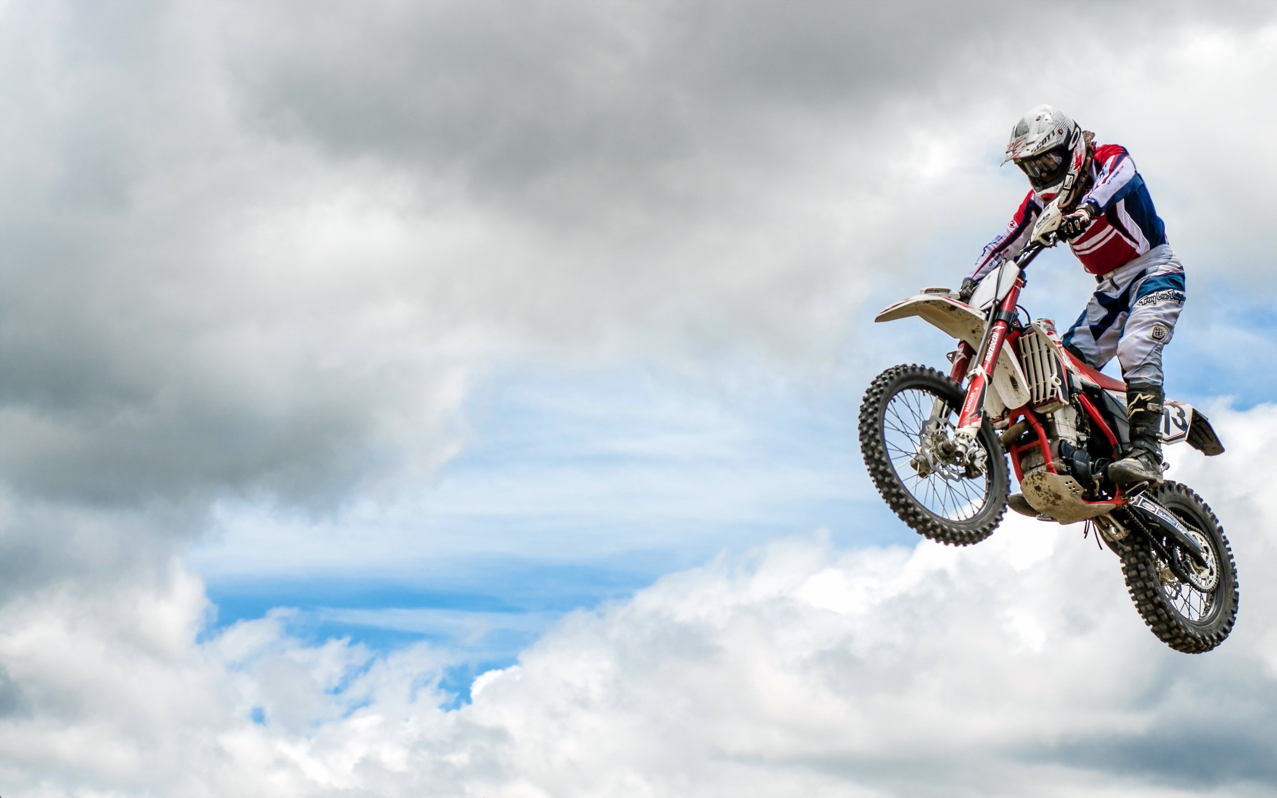 Motocross rider jumping over clouds HD Wallpaper