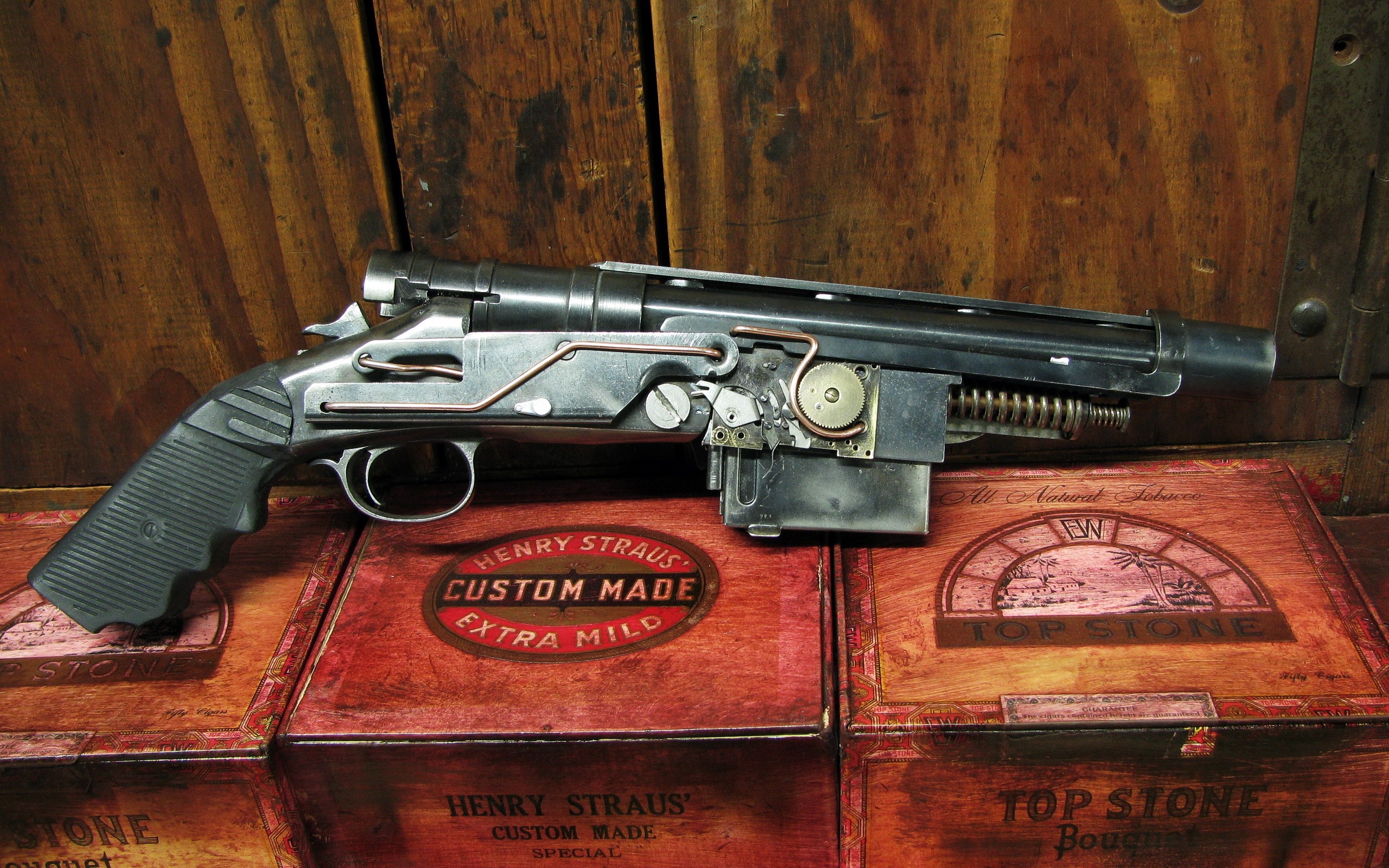 Steampunk pistol on vintage tobacco boxes HD Wallpaper