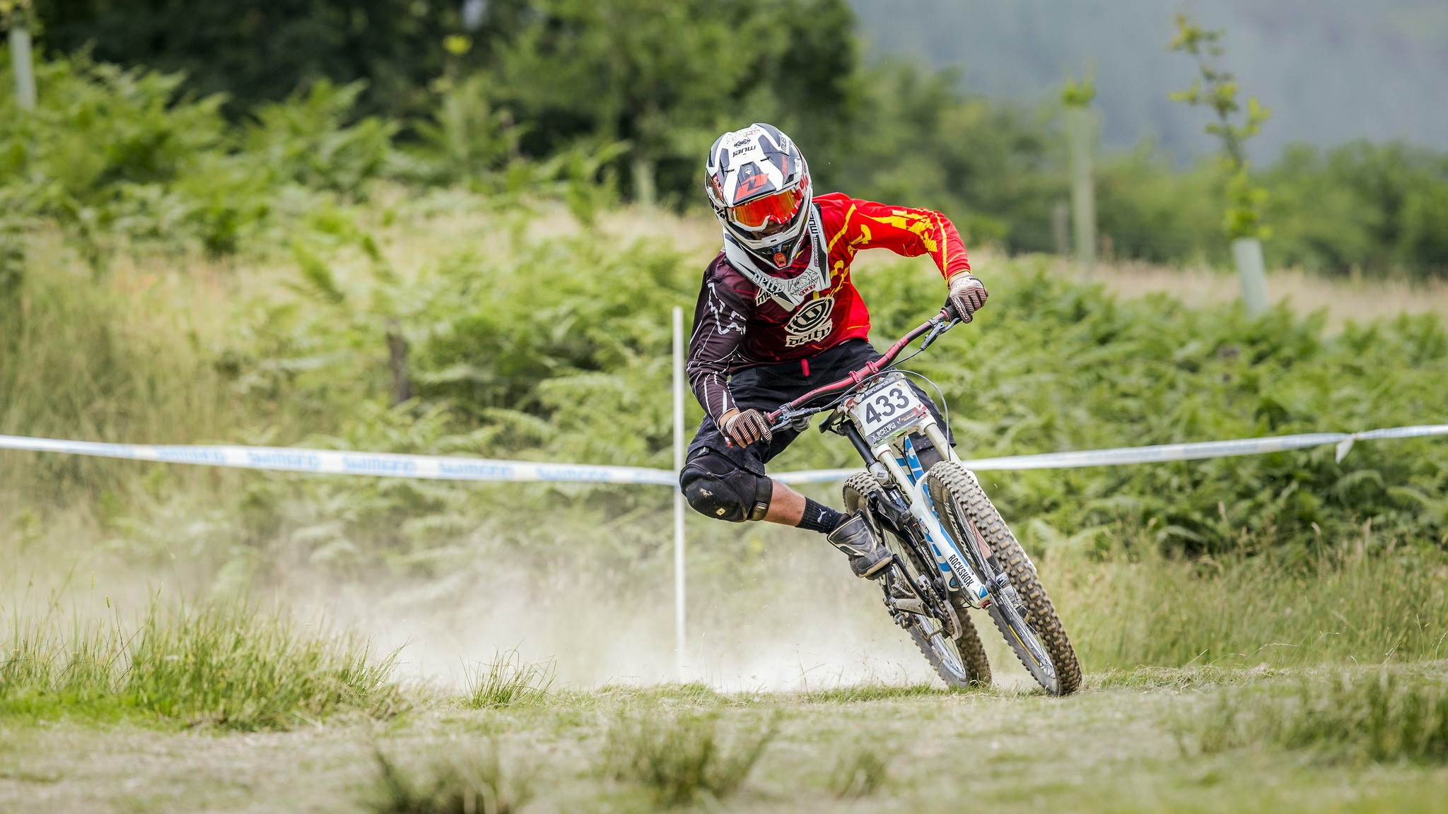 Mountain biker wearing helmet and racing gear HD Wallpaper