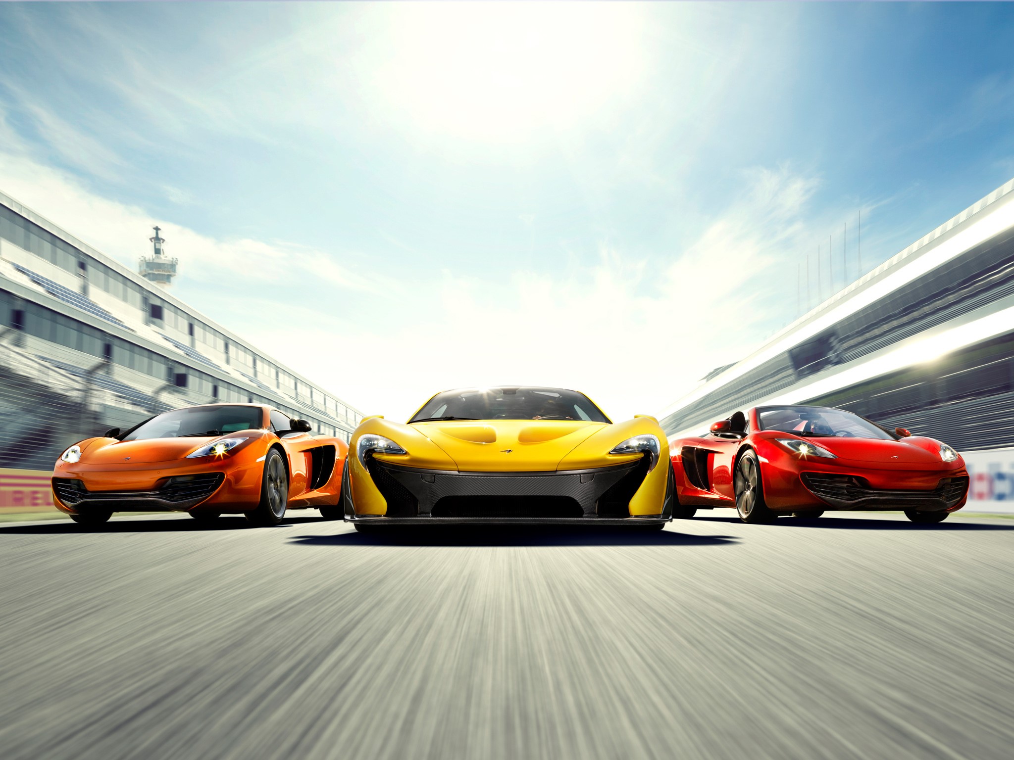 McLaren P1 and MP4-12C cars on a racetrack HD Wallpaper