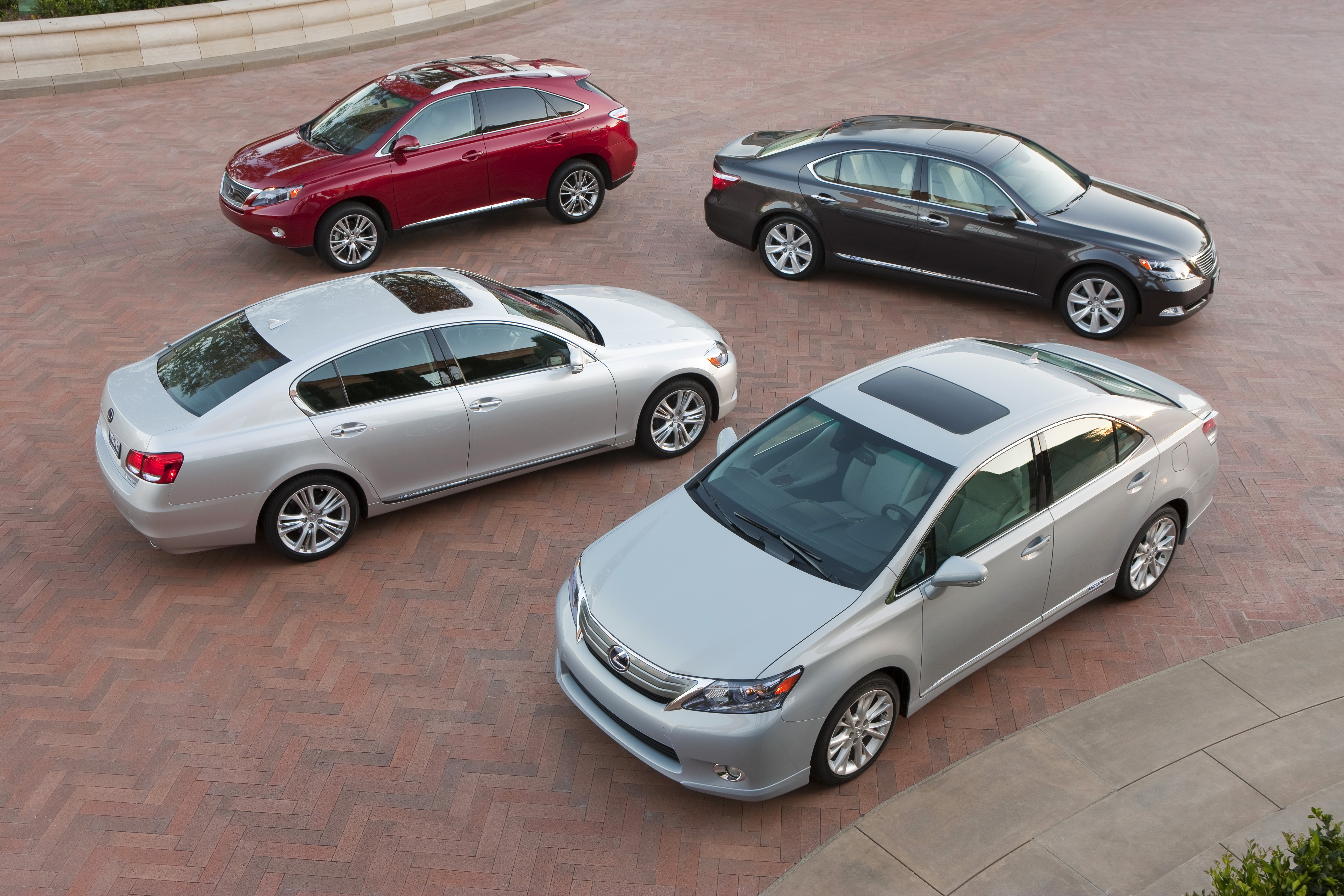 Four Lexus cars parked on a brick driveway HD Wallpaper