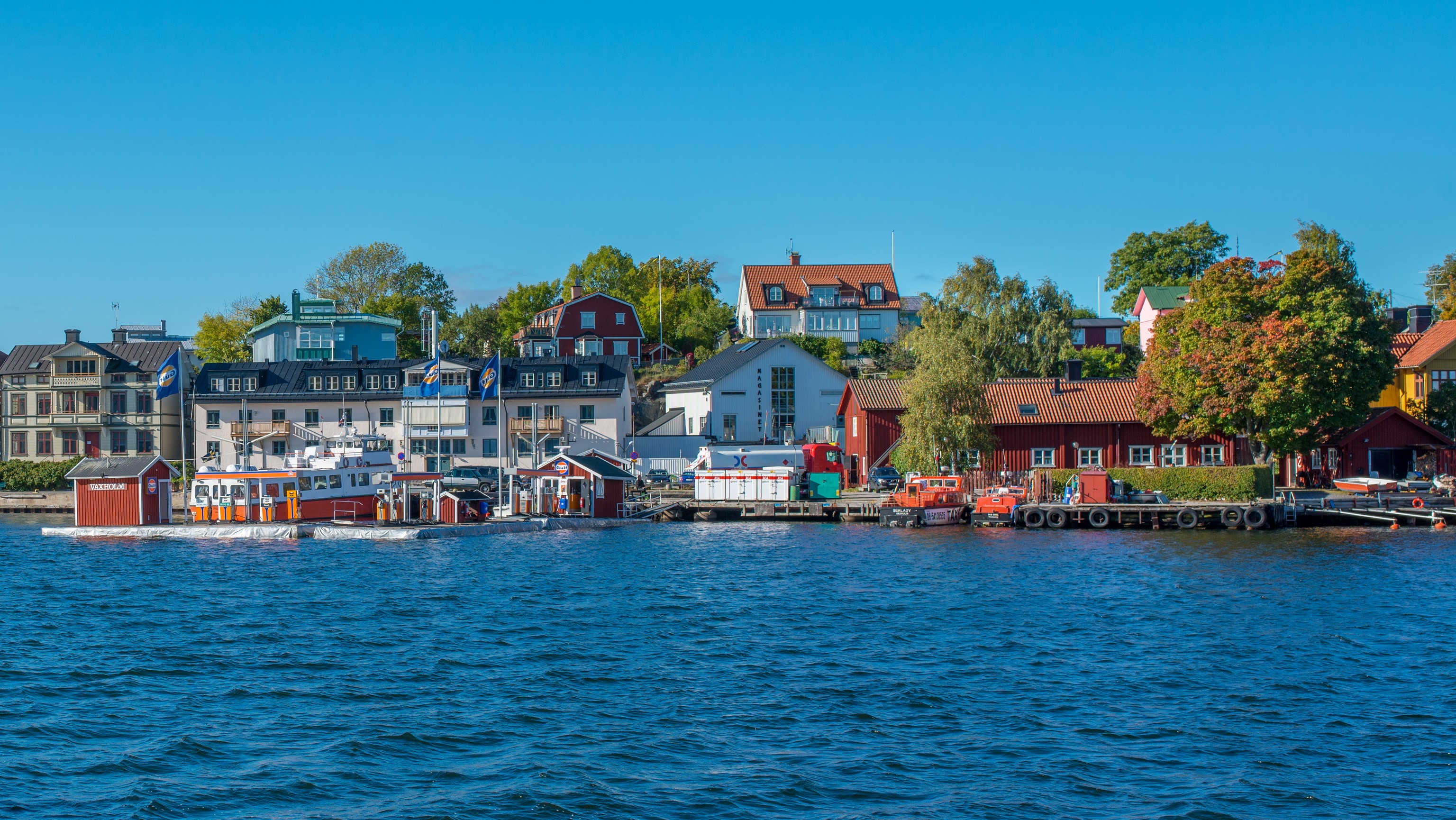 Vaxholm, Sweden waterfront with houses and boats HD Wallpaper
