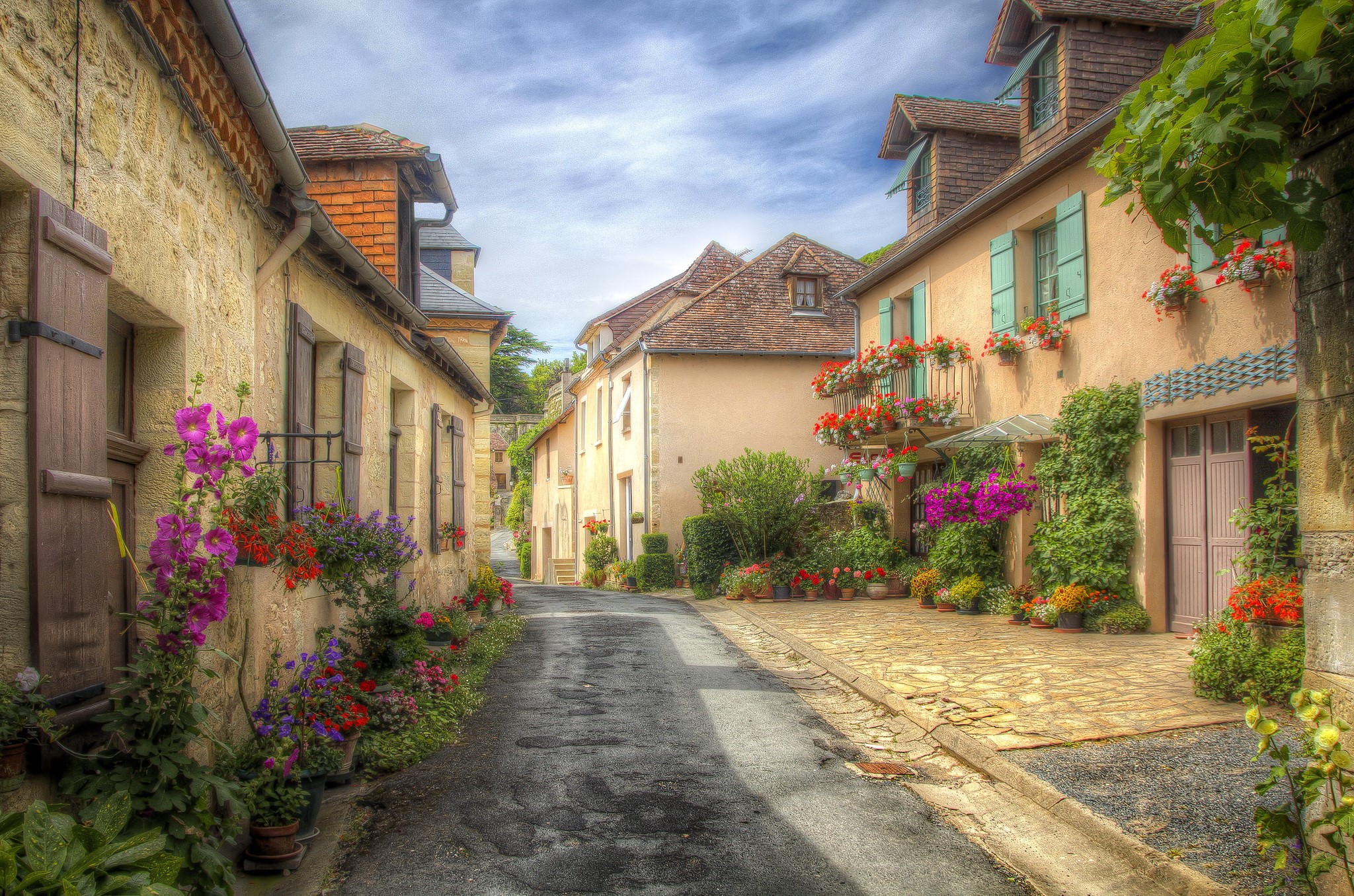 Charming street in Aquitaine, France with houses and flowers HD Wallpaper