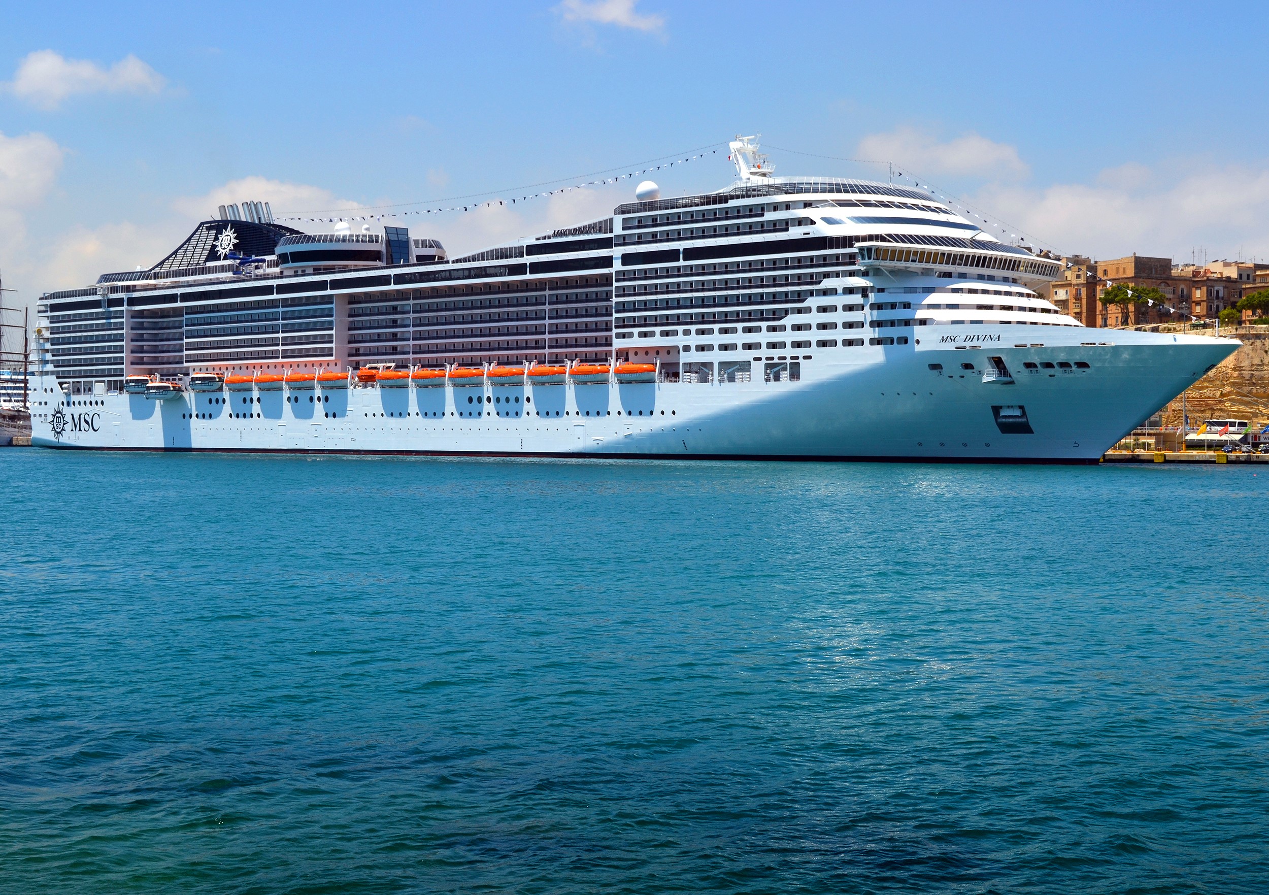 MSC Divina cruise ship docked in a harbor HD Wallpaper