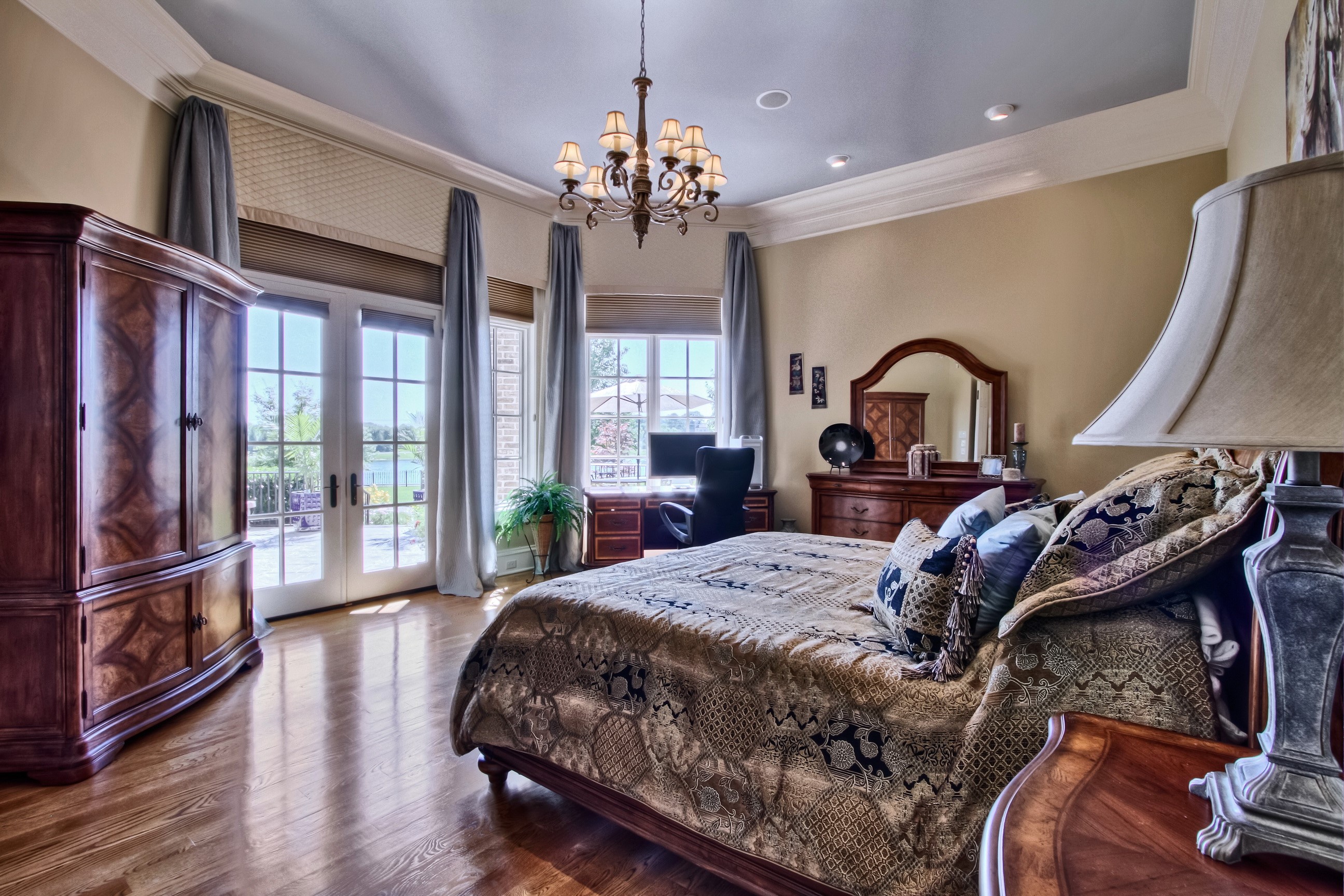 Bedroom with chandelier, bed, and armoire HD Wallpaper