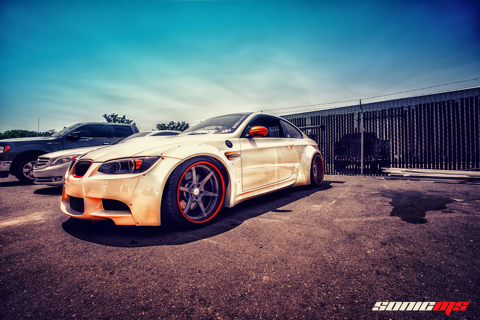 White BMW E92 M3 with orange accents on asphalt HD Wallpaper