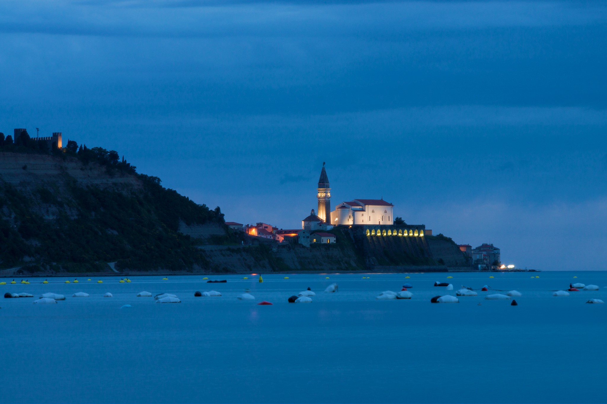 Coastal town with church and castle at dusk HD Wallpaper