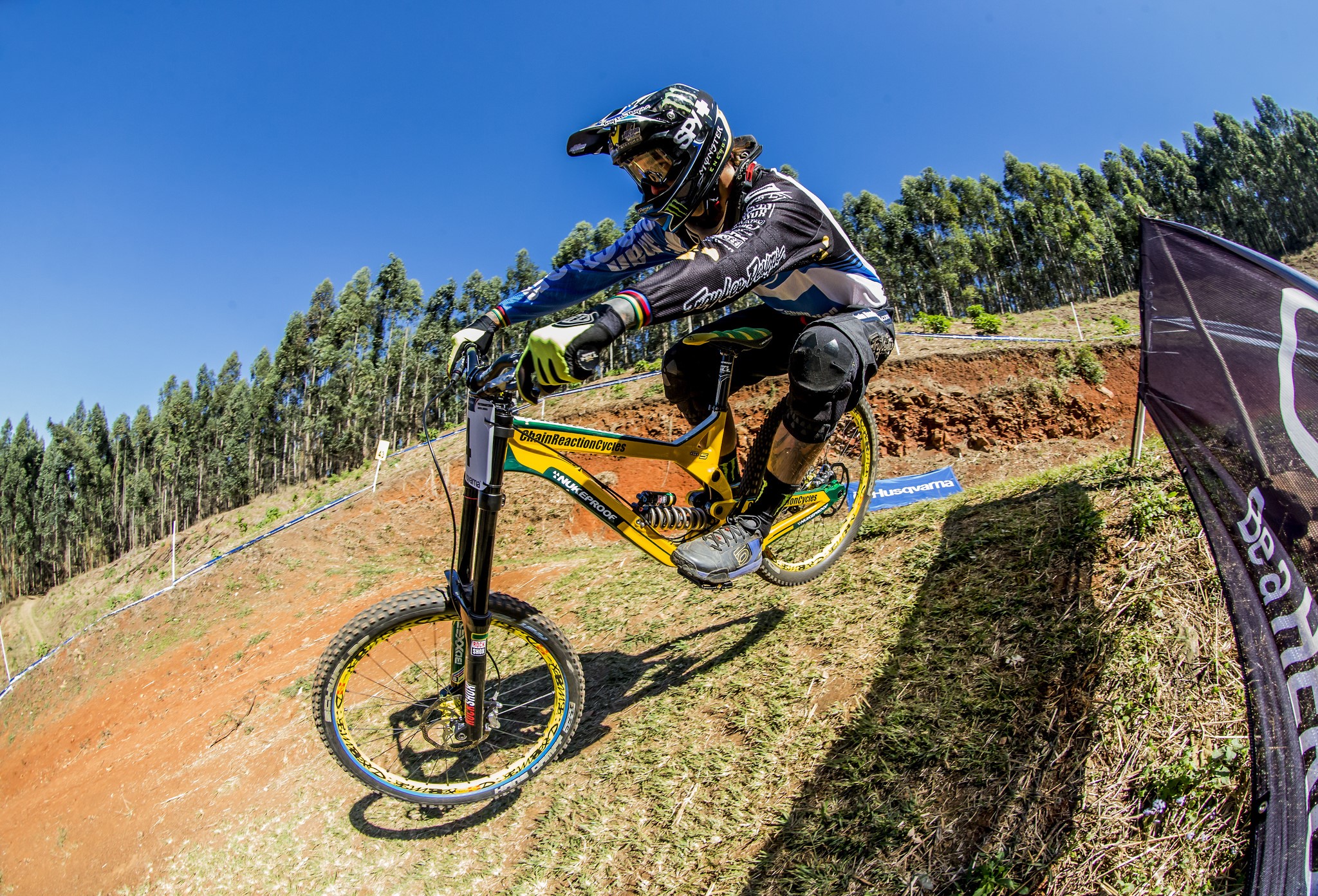 Downhill mountain biker in mid-air jump HD Wallpaper