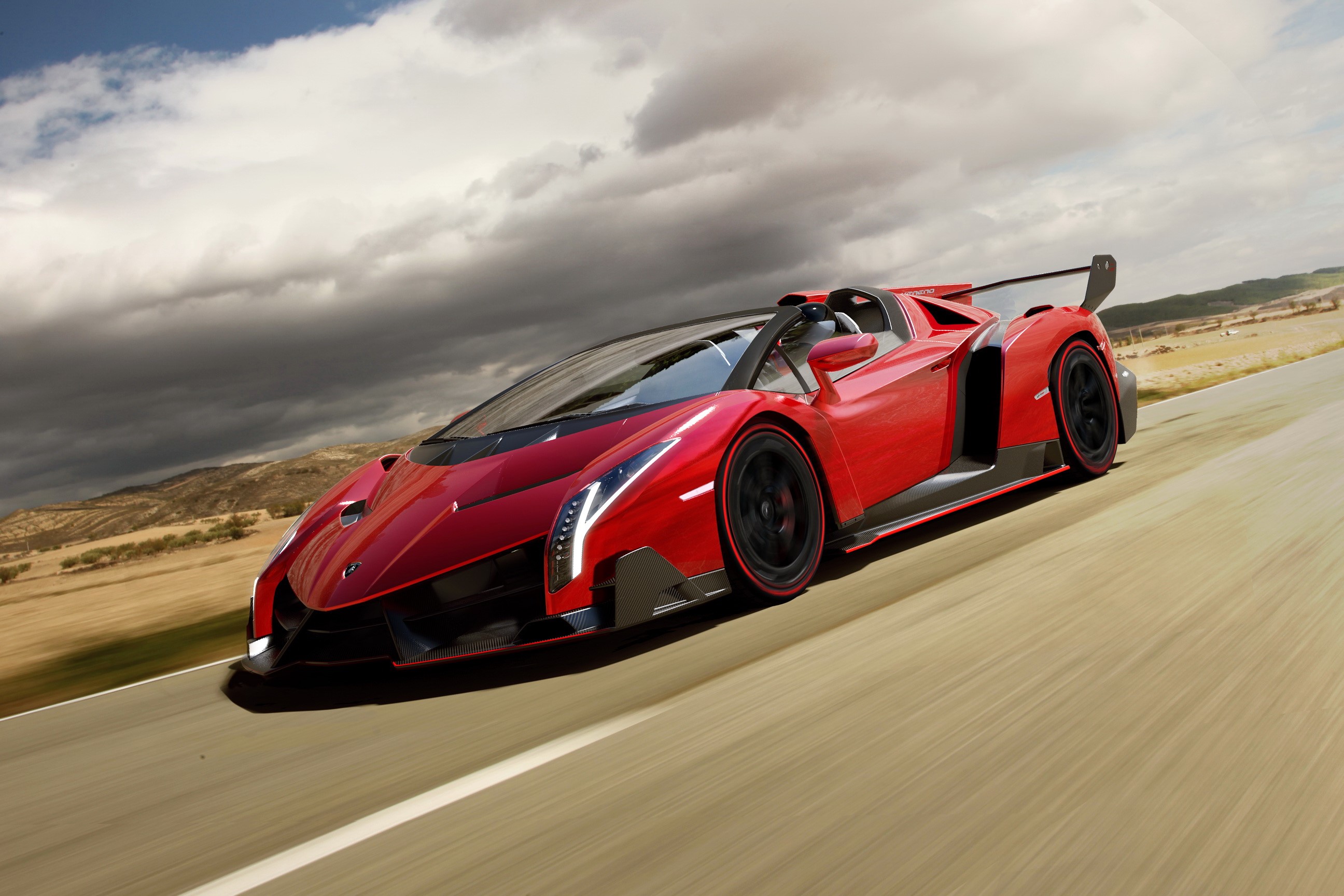 Red 2013 Lamborghini Veneno Roadster driving on a road HD Wallpaper