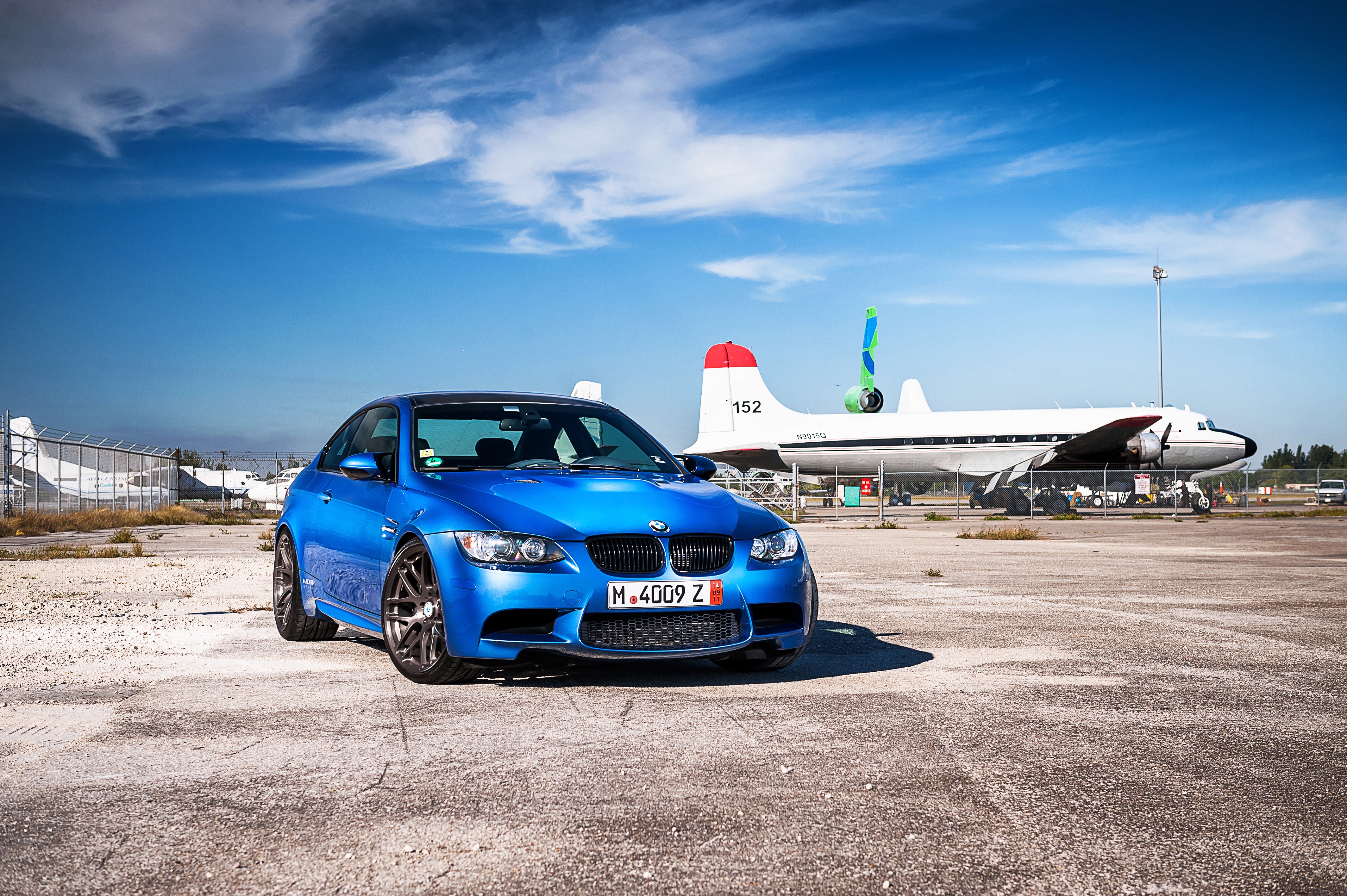 Blue BMW M3 E92 parked at an airfield HD Wallpaper
