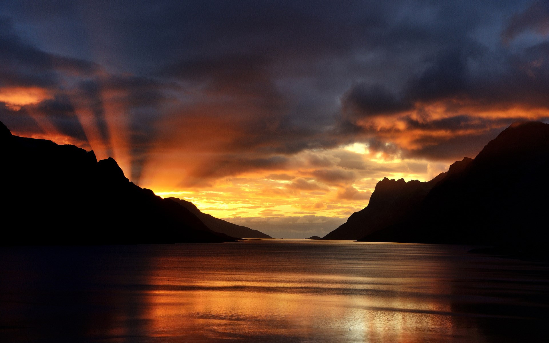 Sunset over a fjord with mountains and clouds HD Wallpaper
