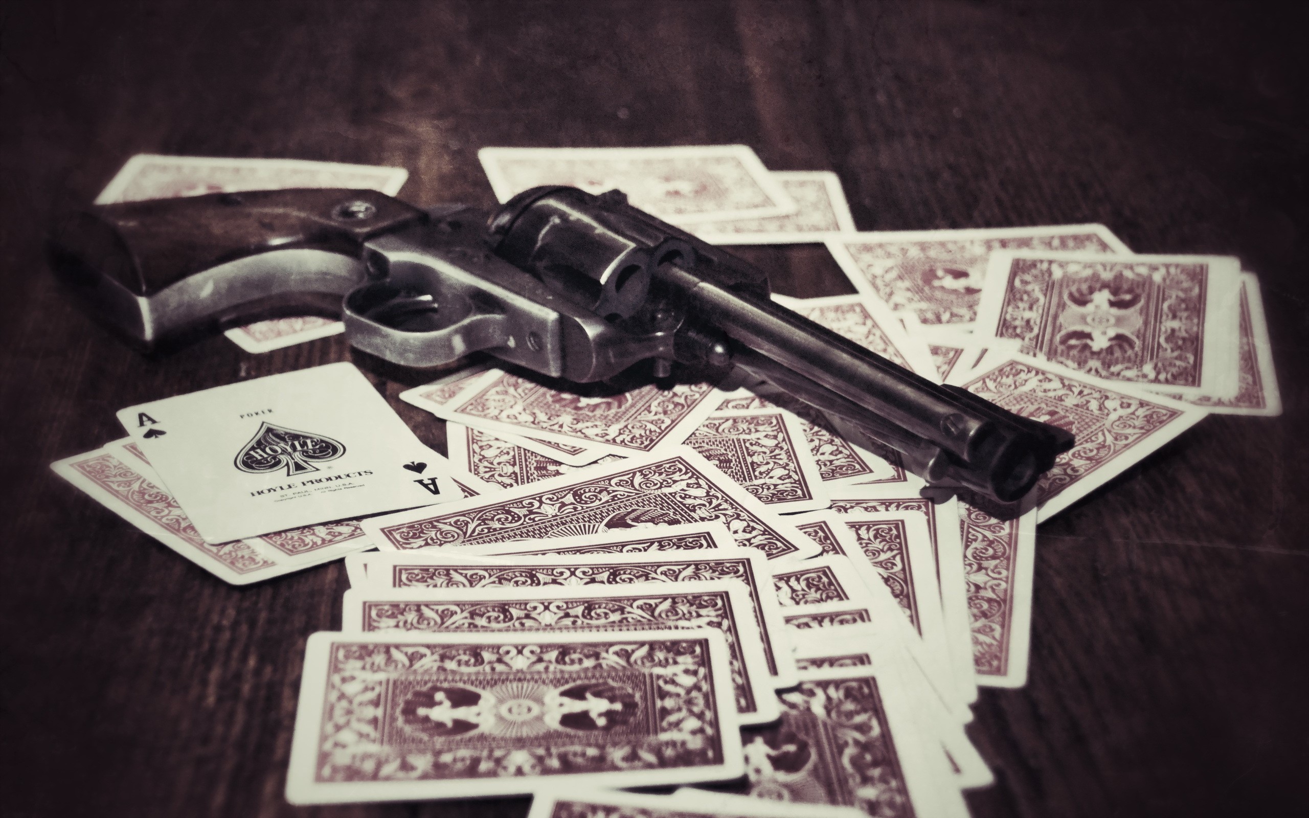 Revolver on a pile of playing cards HD Wallpaper