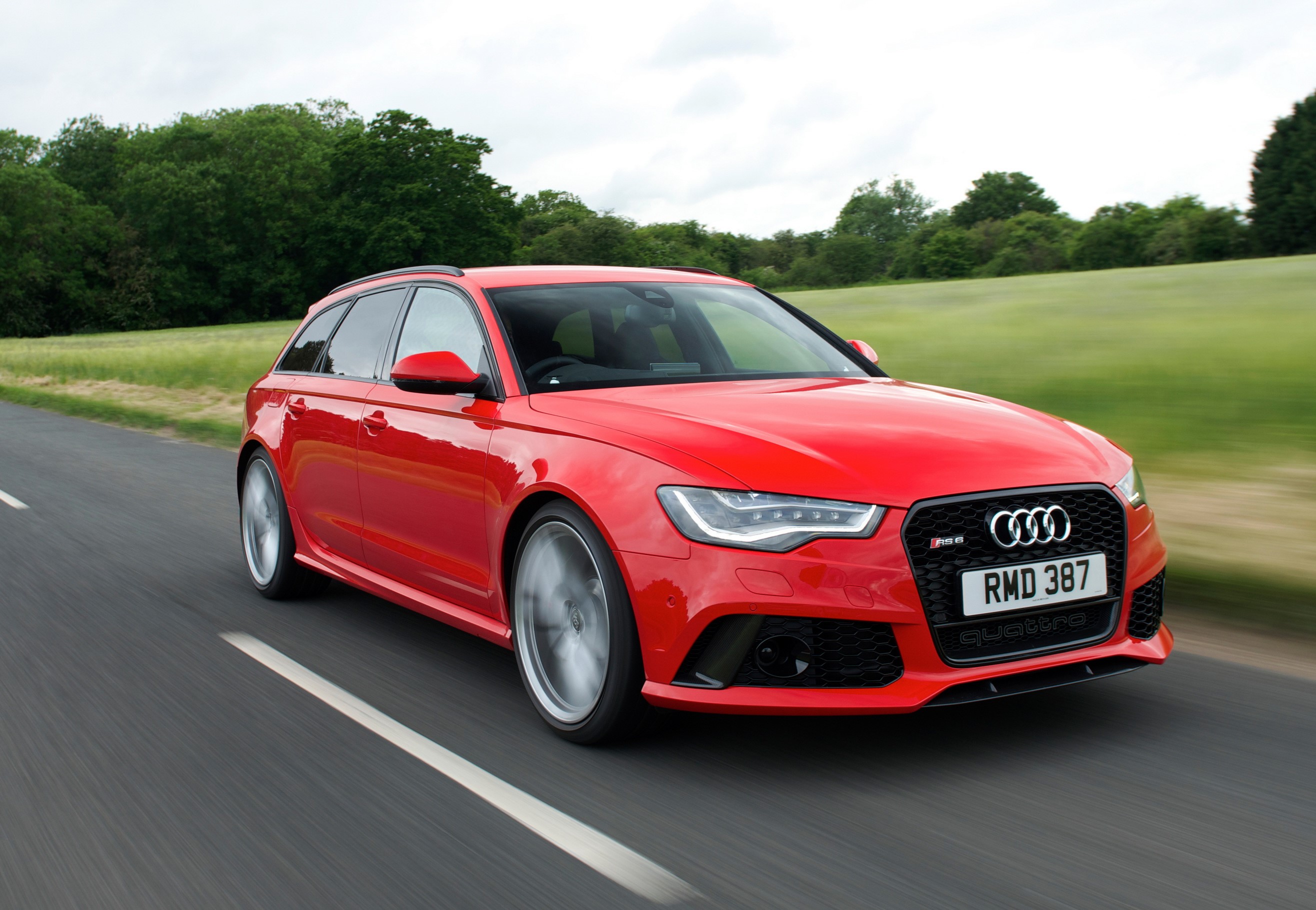 Red 2013 Audi RS6 Avant driving on a road HD Wallpaper