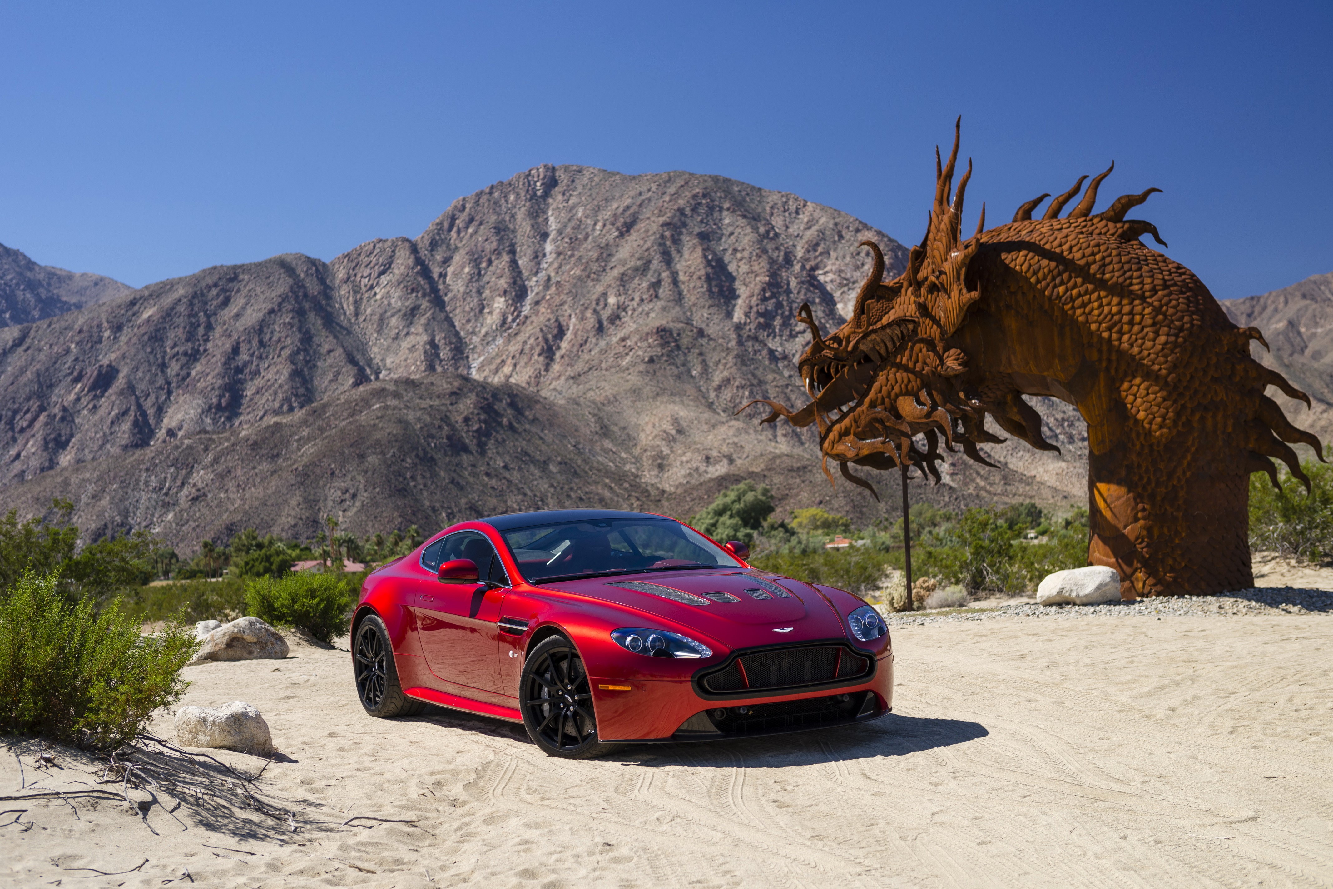 Red Aston Martin V12 Vantage S near Dragon Sculpture HD Wallpaper
