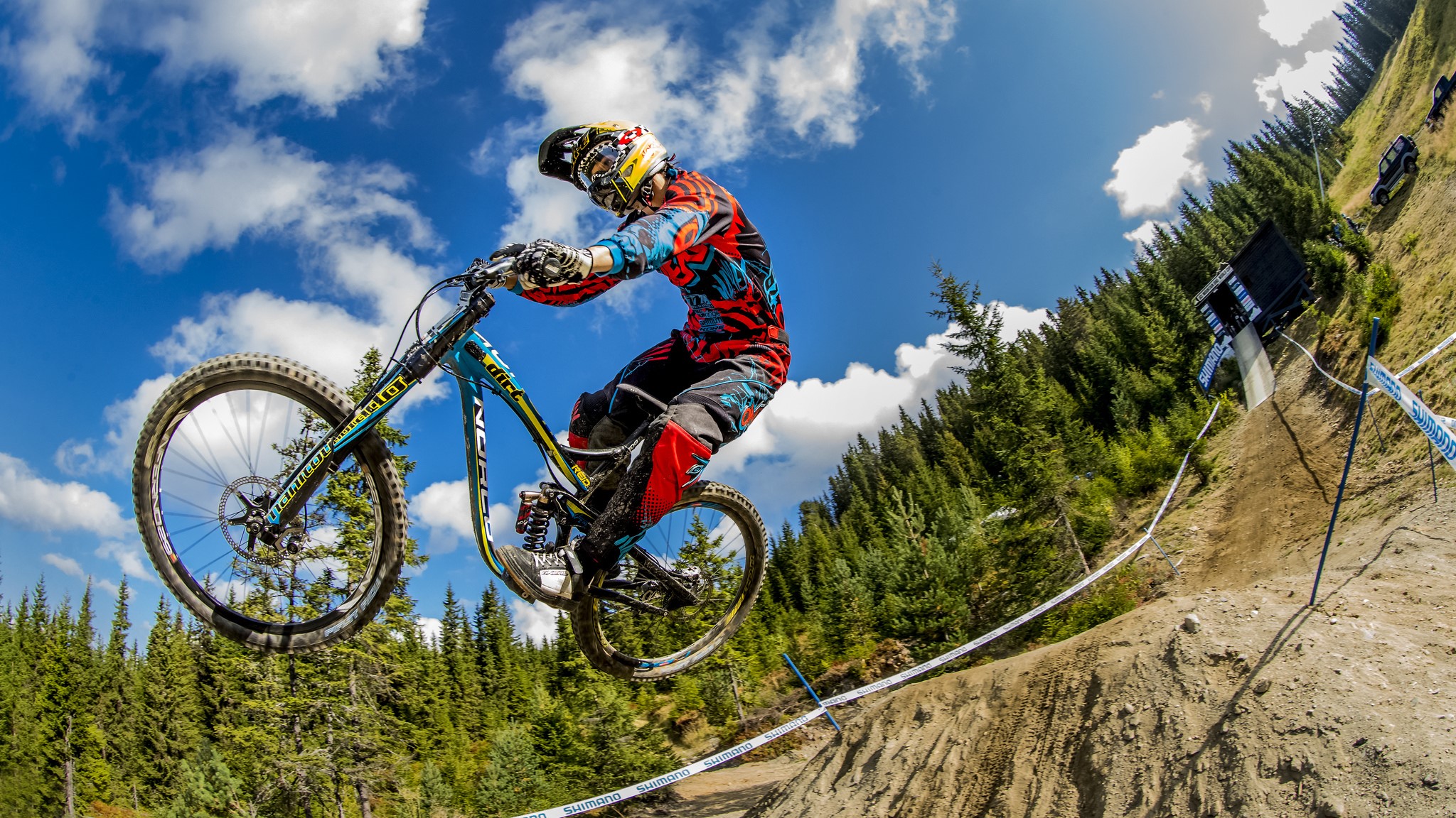 Mountain biker jumping on a dirt track HD Wallpaper