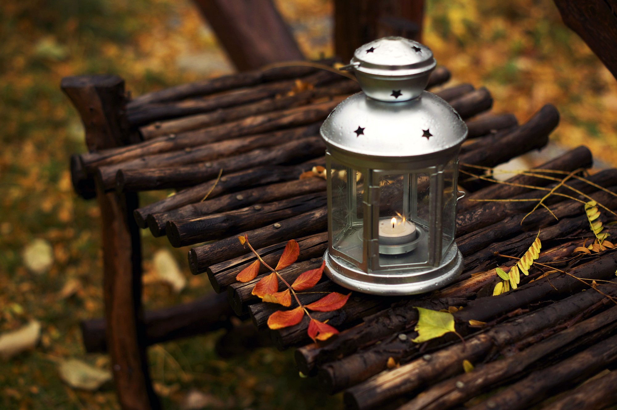 Lantern with lit candle on wooden surface HD Wallpaper