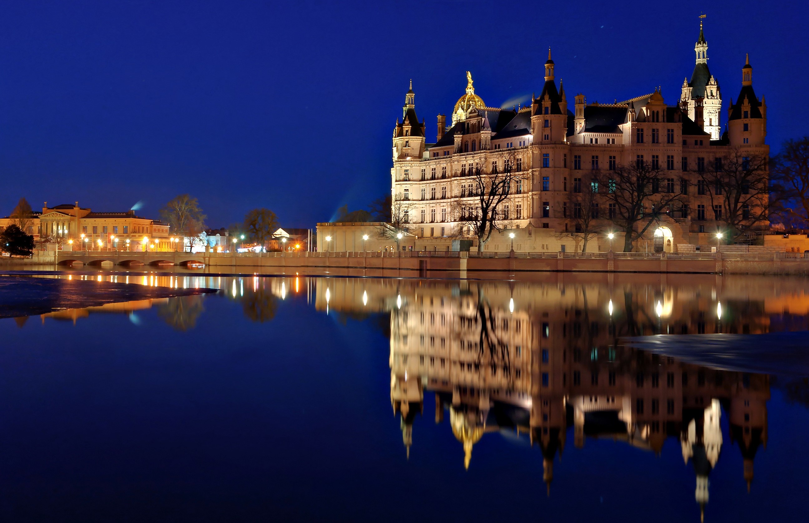 Schwerin Castle reflected in water at night HD Wallpaper