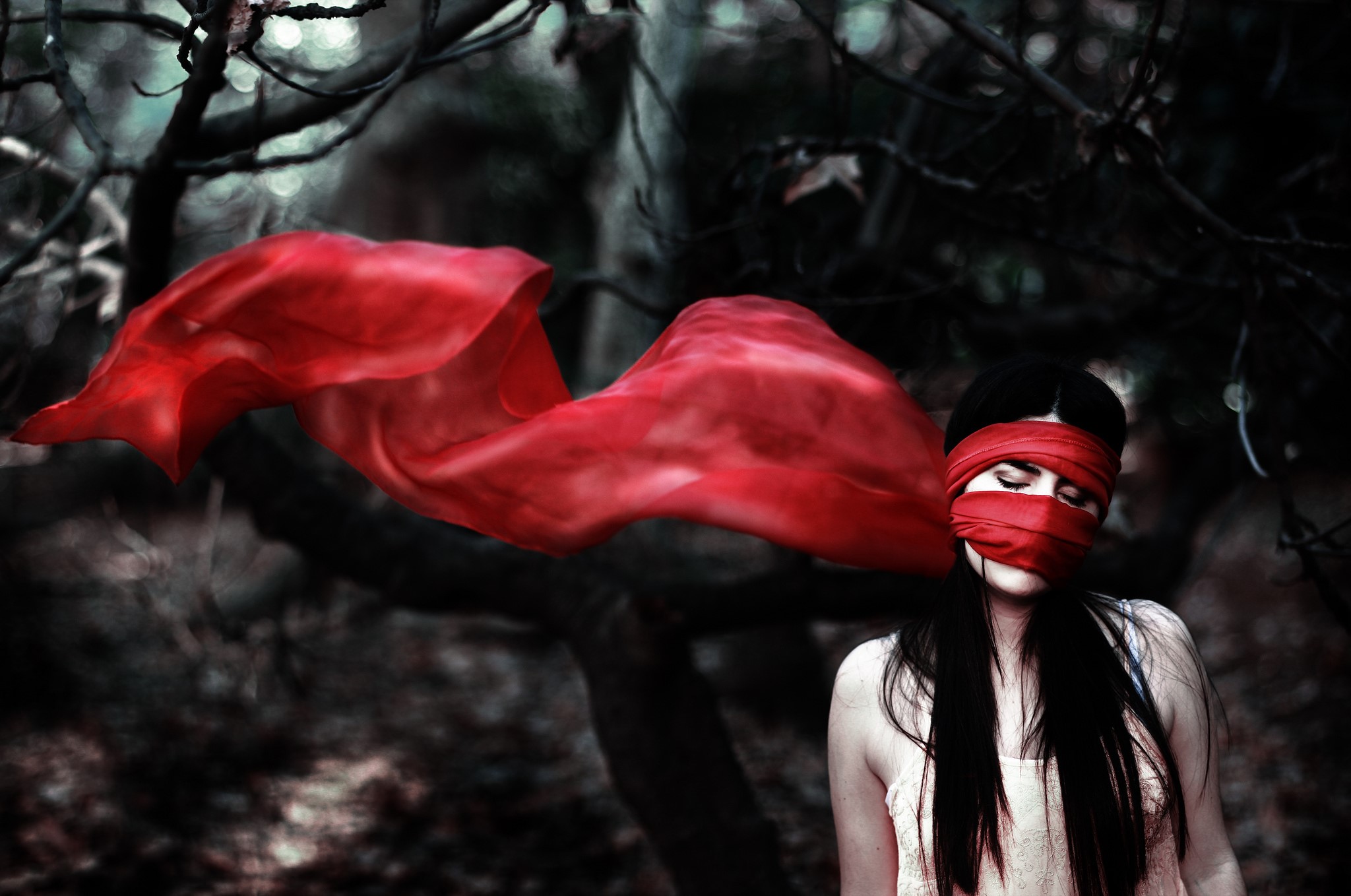 Woman with red blindfold and flowing fabric in dark forest HD Wallpaper