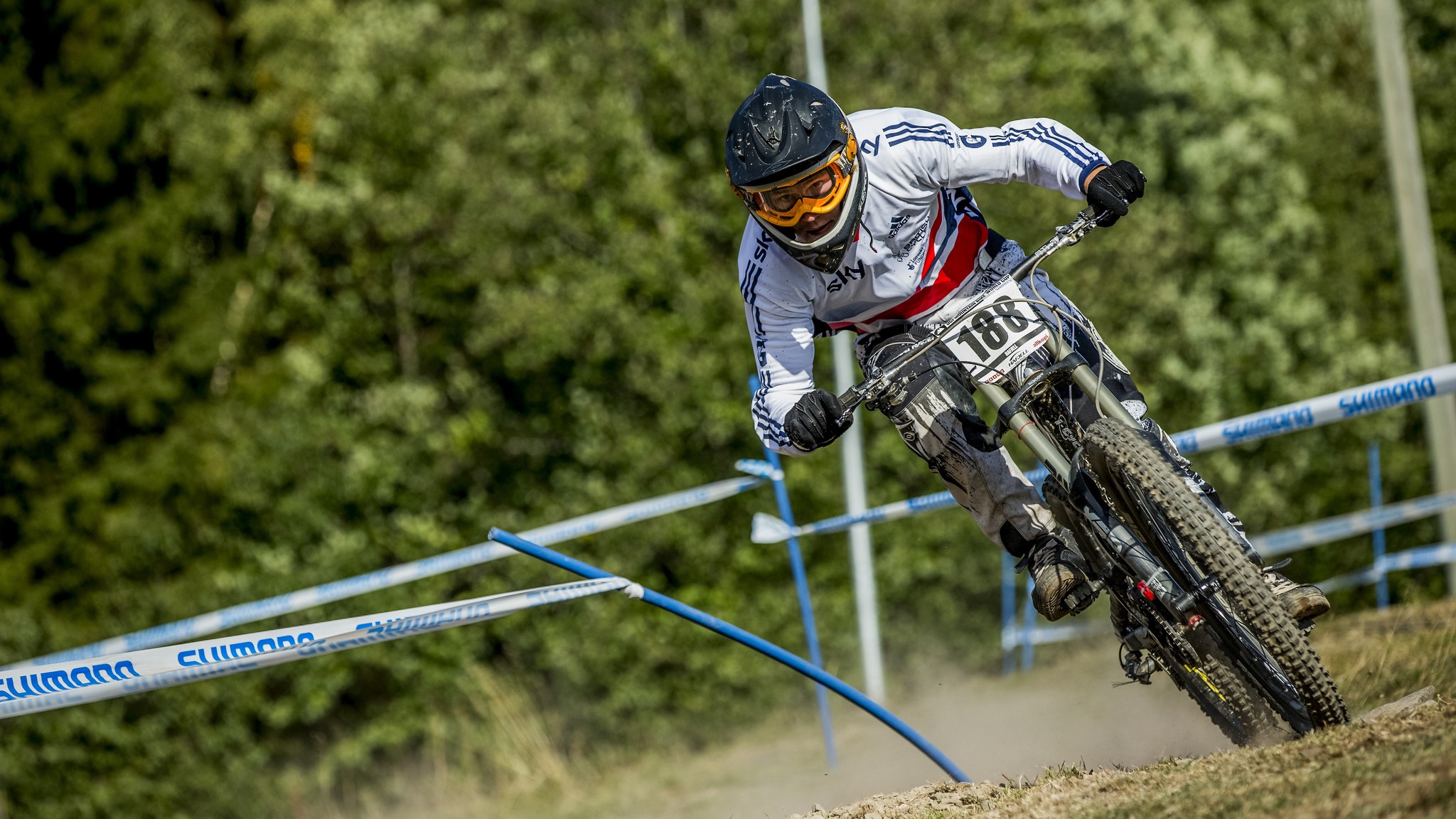Downhill mountain biker wearing a helmet and goggles HD Wallpaper