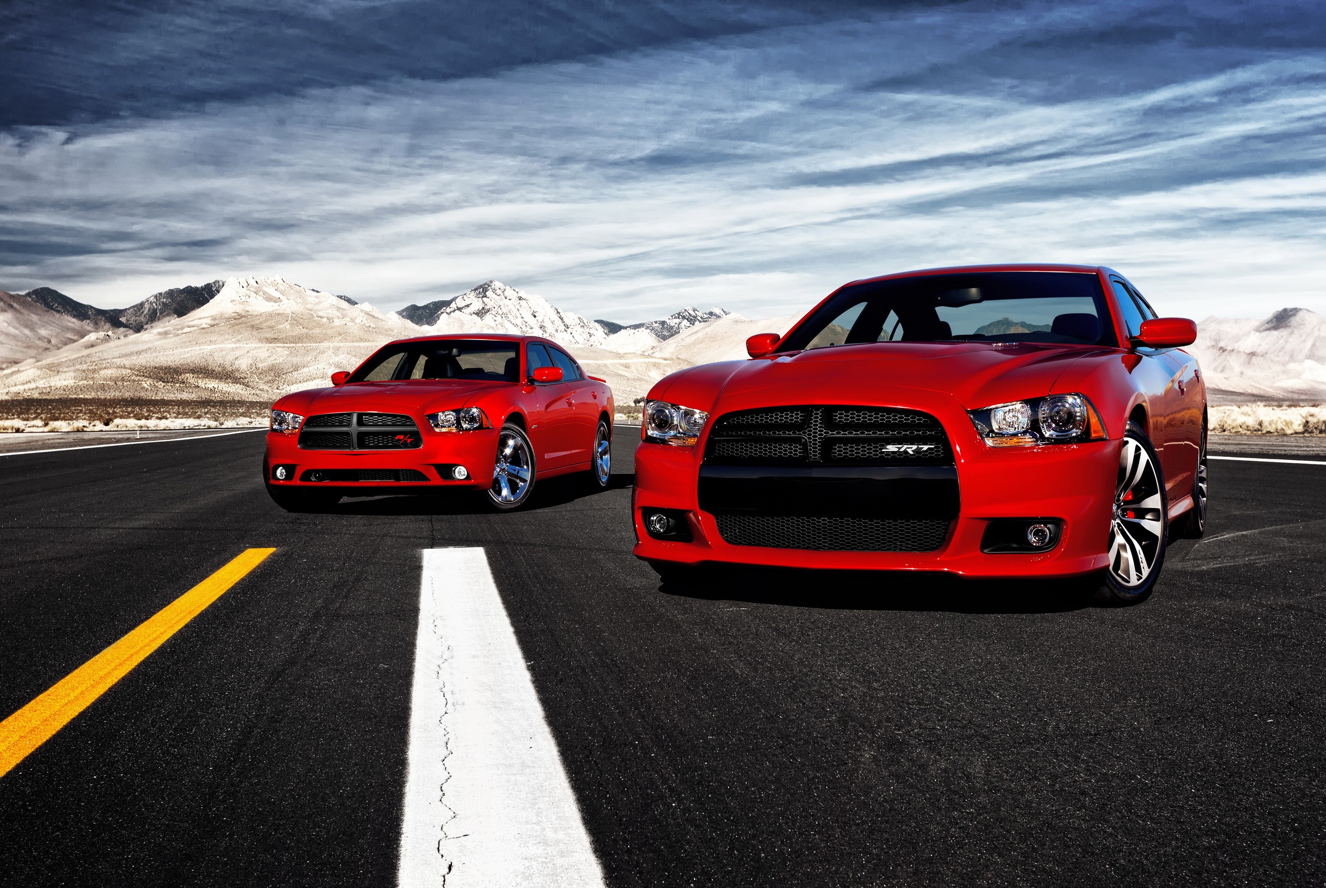 Two red Dodge Charger SRT8 cars on asphalt road HD Wallpaper