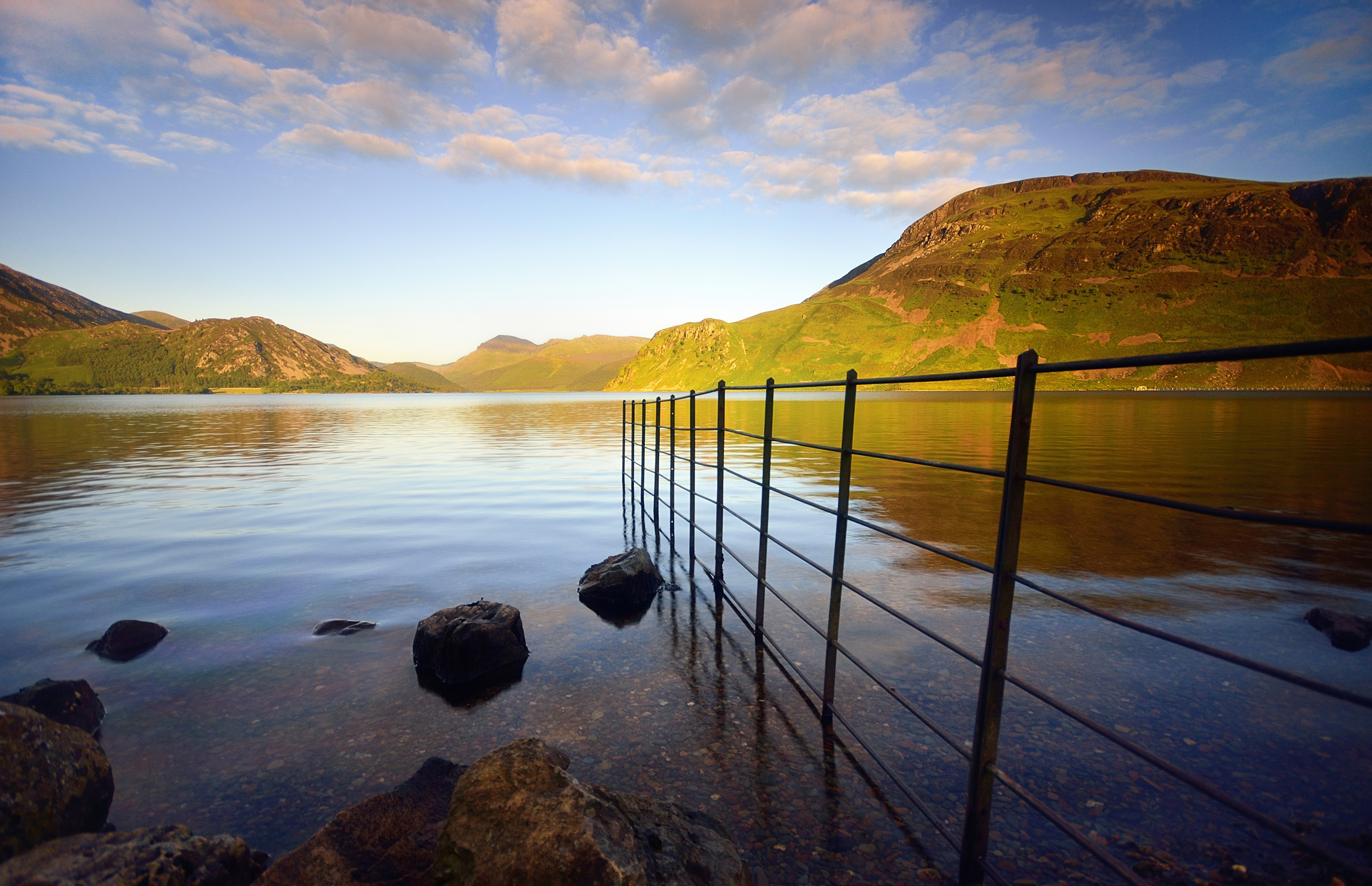 Scenery of a lake with mountains and a fence HD Wallpaper