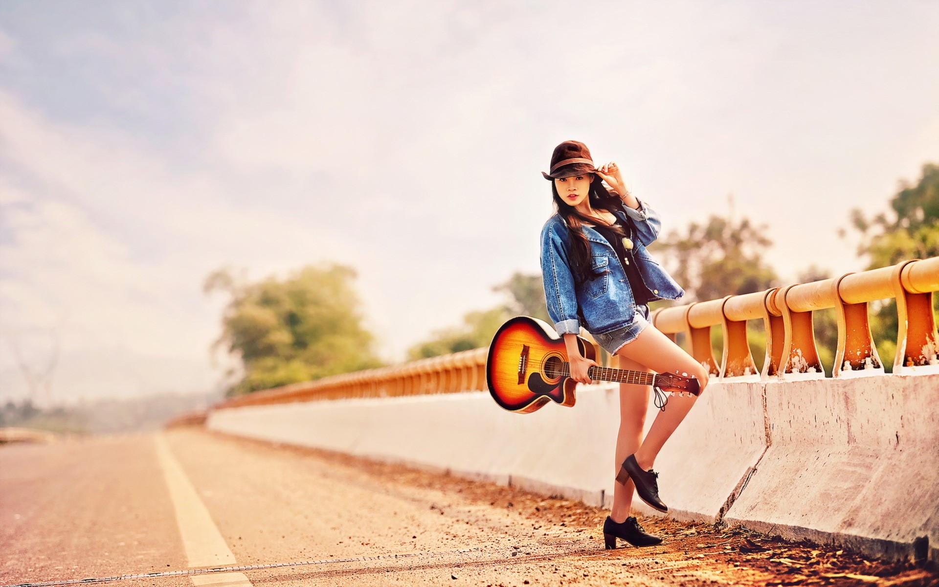Asian woman with guitar on a road HD Wallpaper