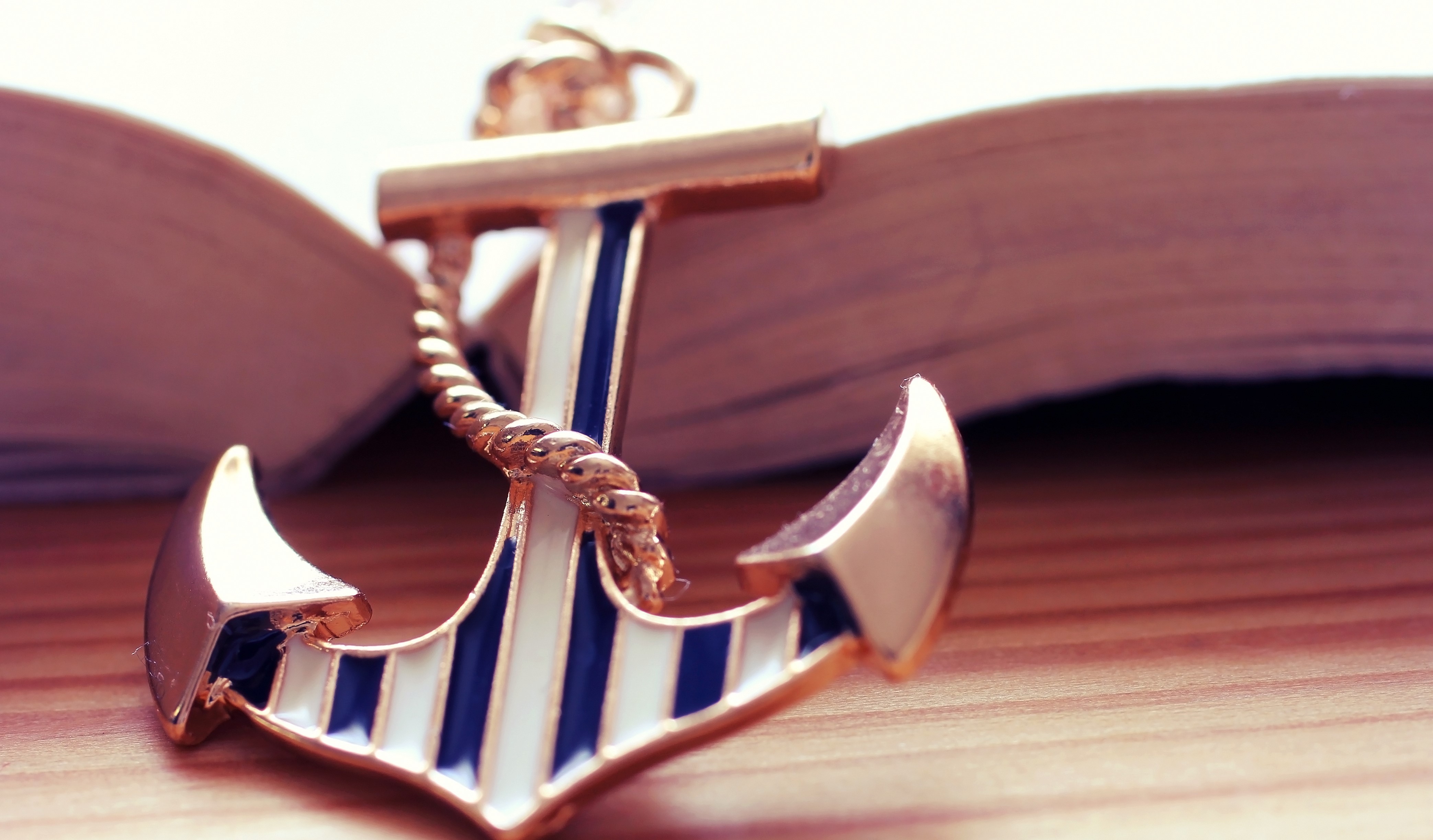 Anchor souvenir on an open book HD Wallpaper