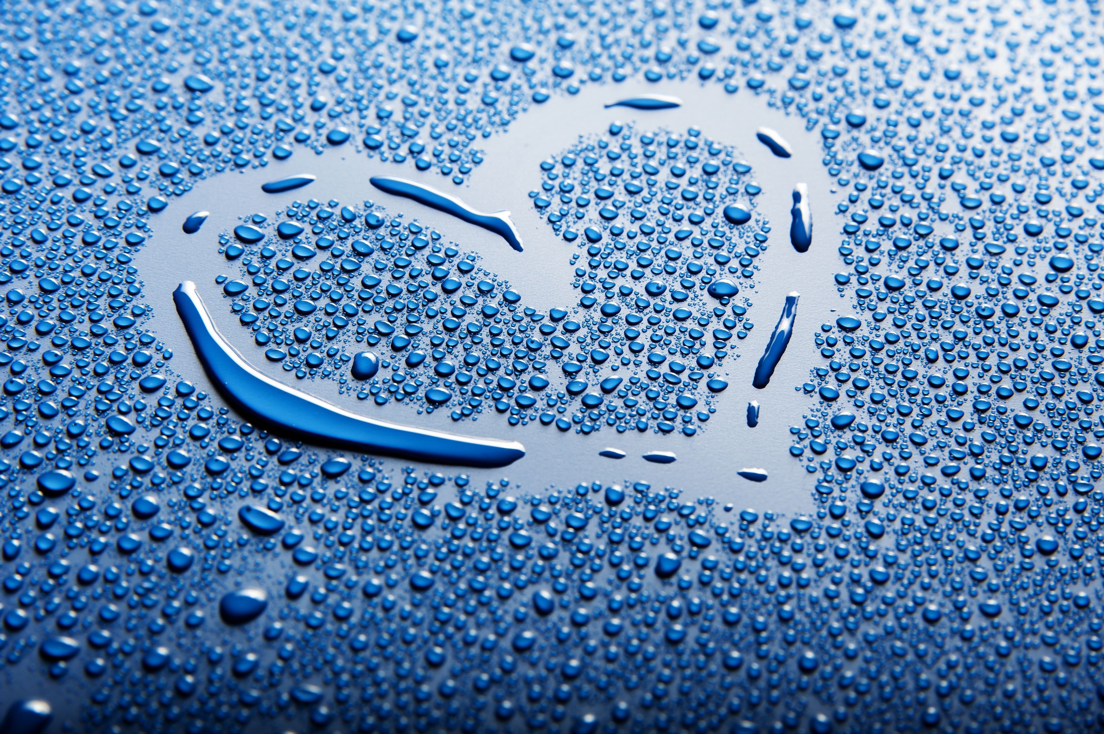 Heart shape made of water drops on a blue surface HD Wallpaper