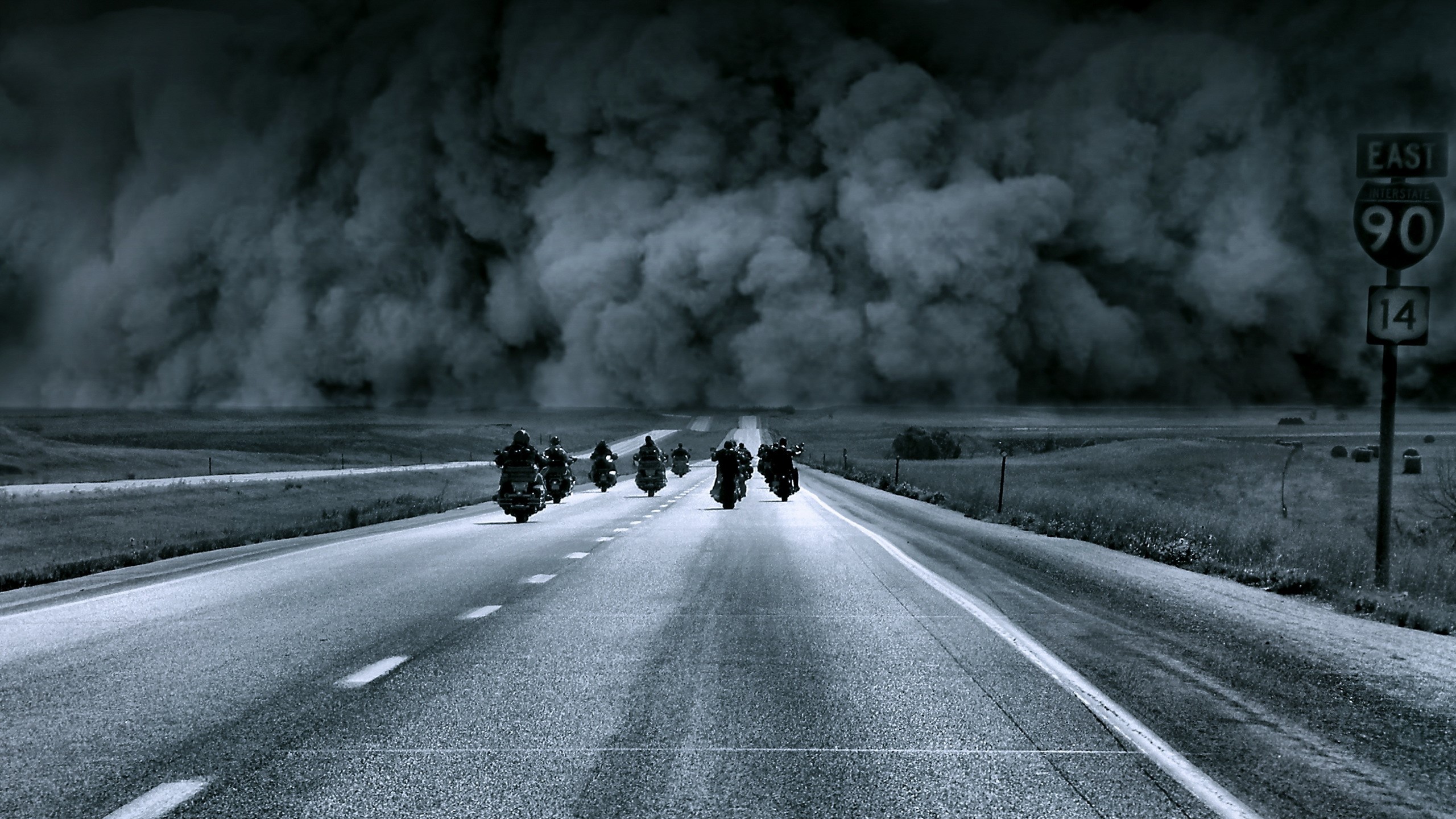 Motorcyclists riding on a road during a dust storm HD Wallpaper