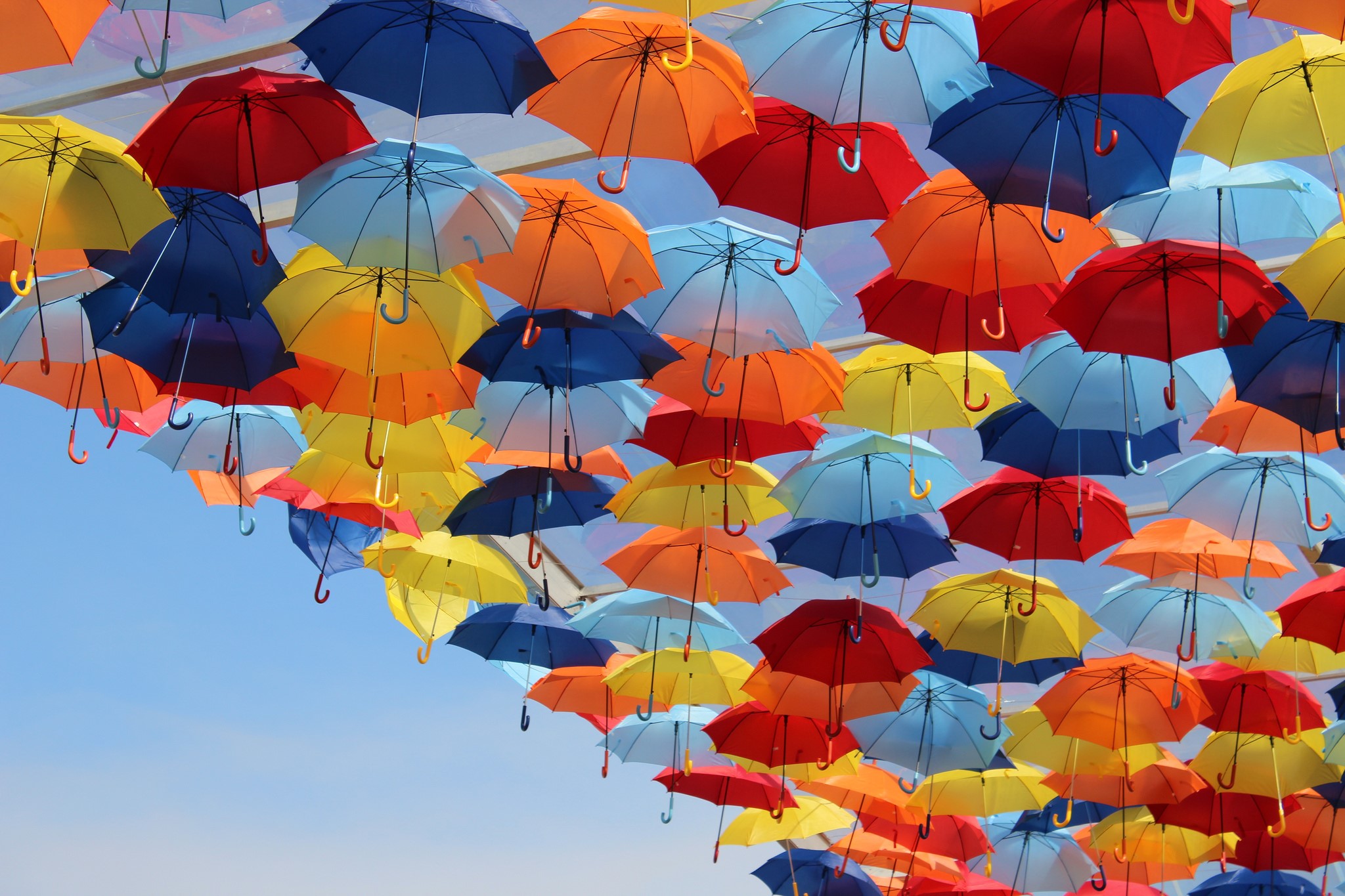 Colorful umbrellas suspended in the sky HD Wallpaper