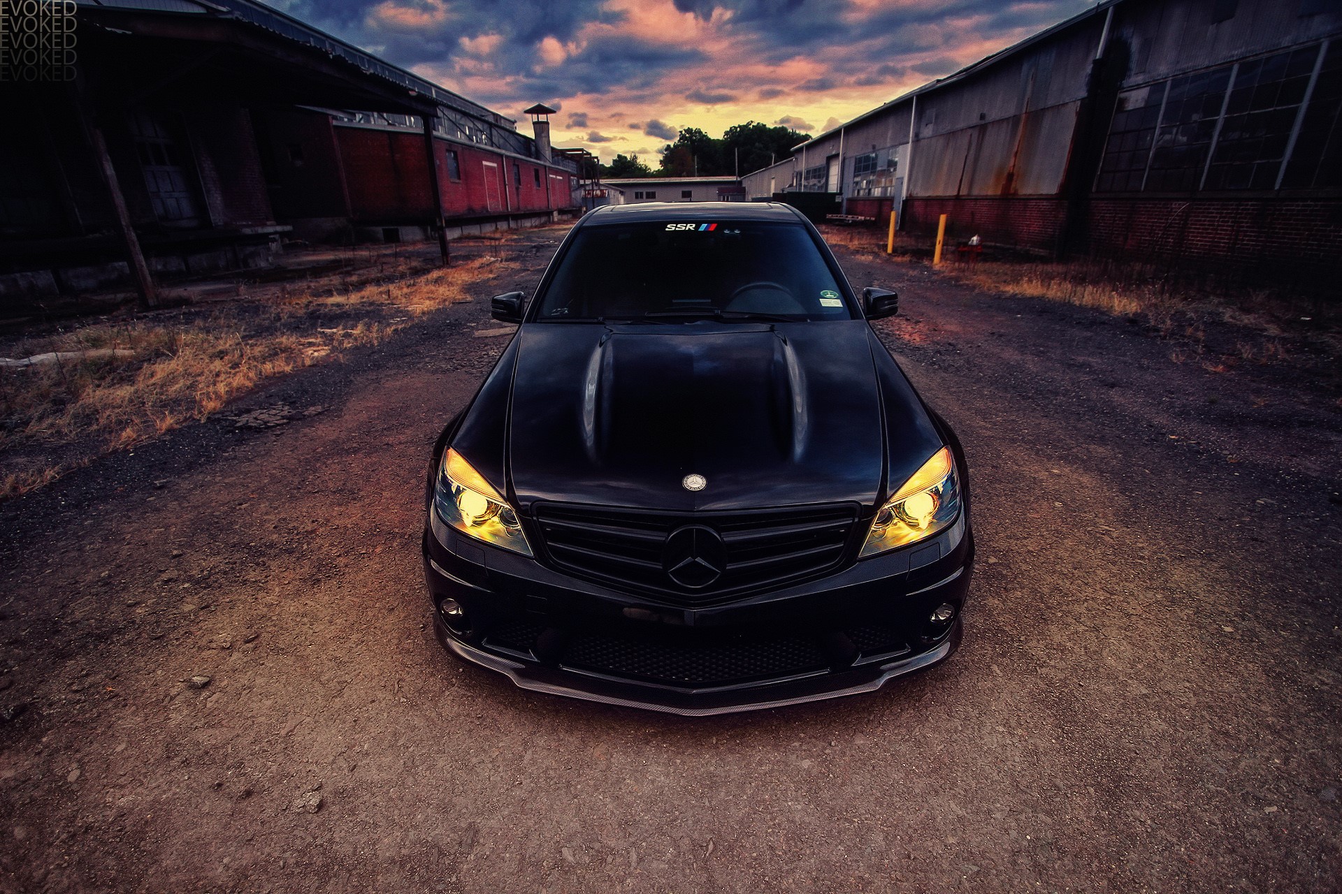 Black Mercedes-Benz C63 AMG parked on dirt road HD Wallpaper