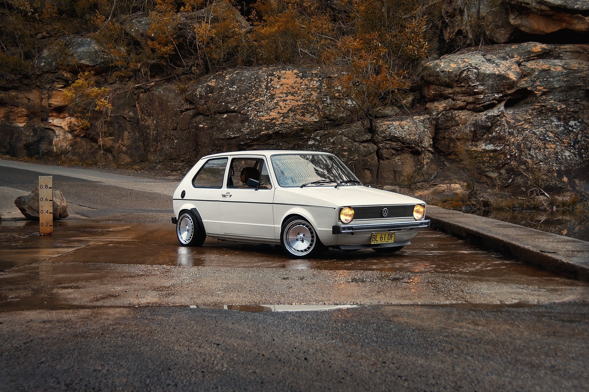 White Volkswagen Golf parked on wet road HD Wallpaper