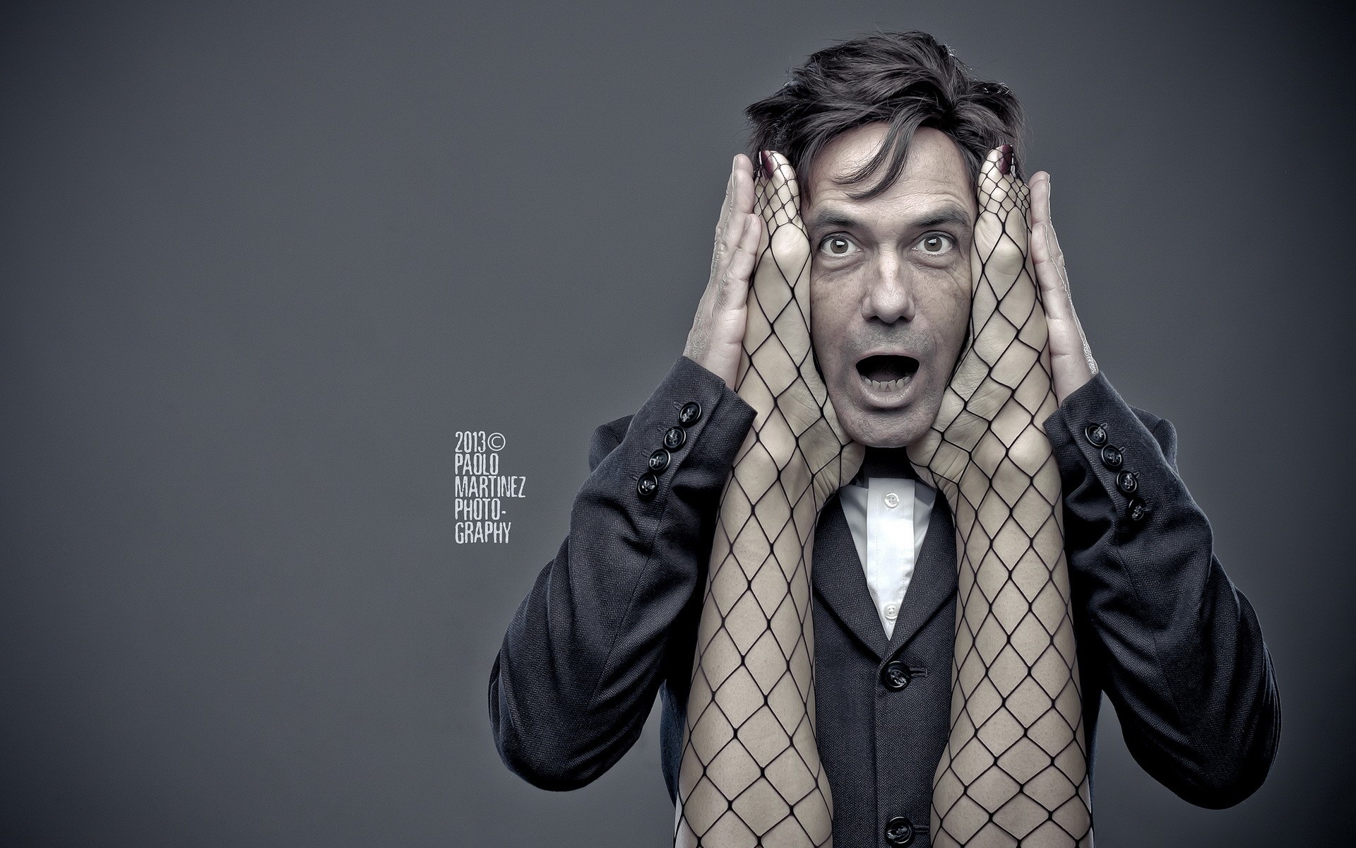 Man with fishnet-clad legs over his face HD Wallpaper