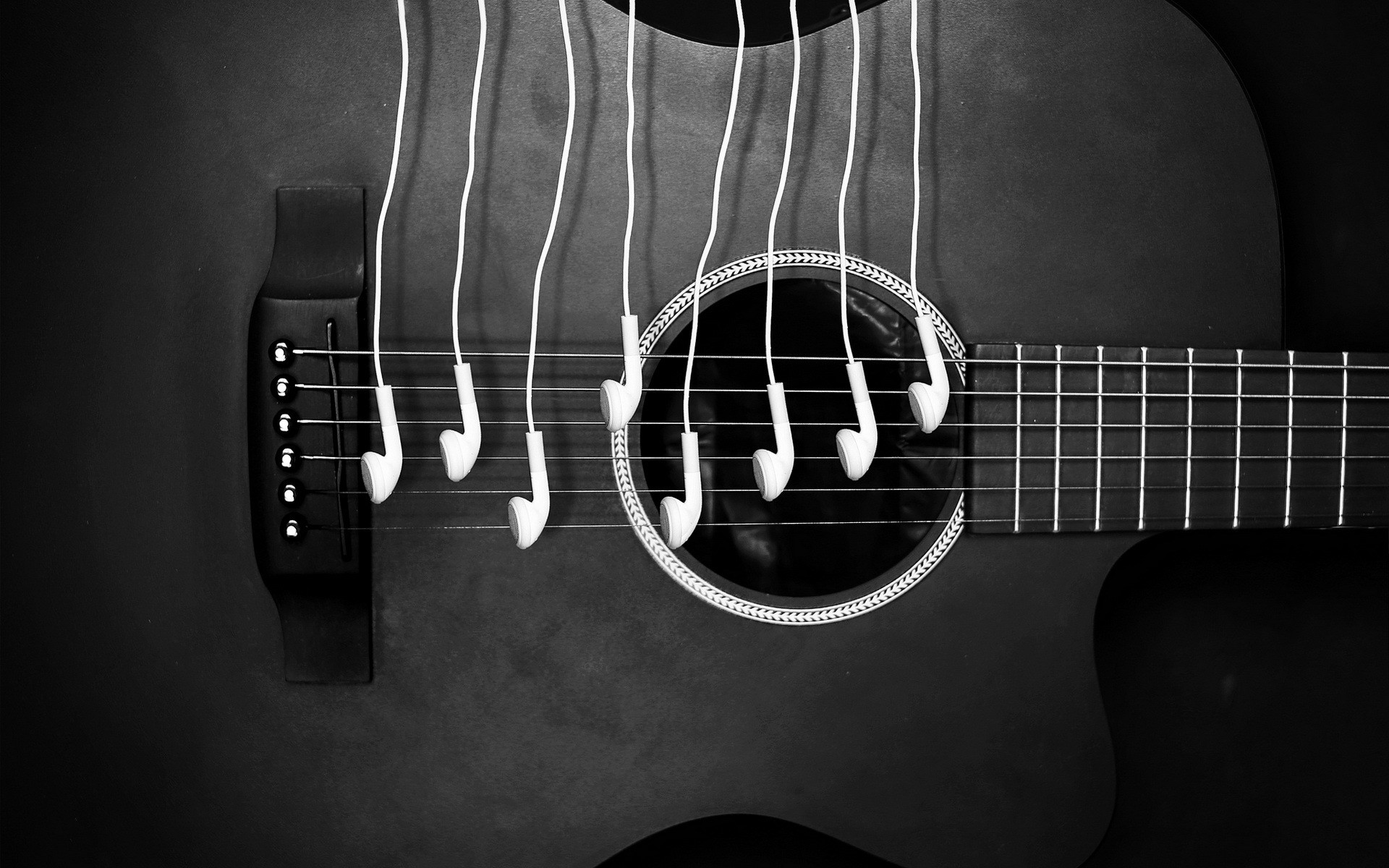 Guitar with Earbuds Hanging from Strings HD Wallpaper