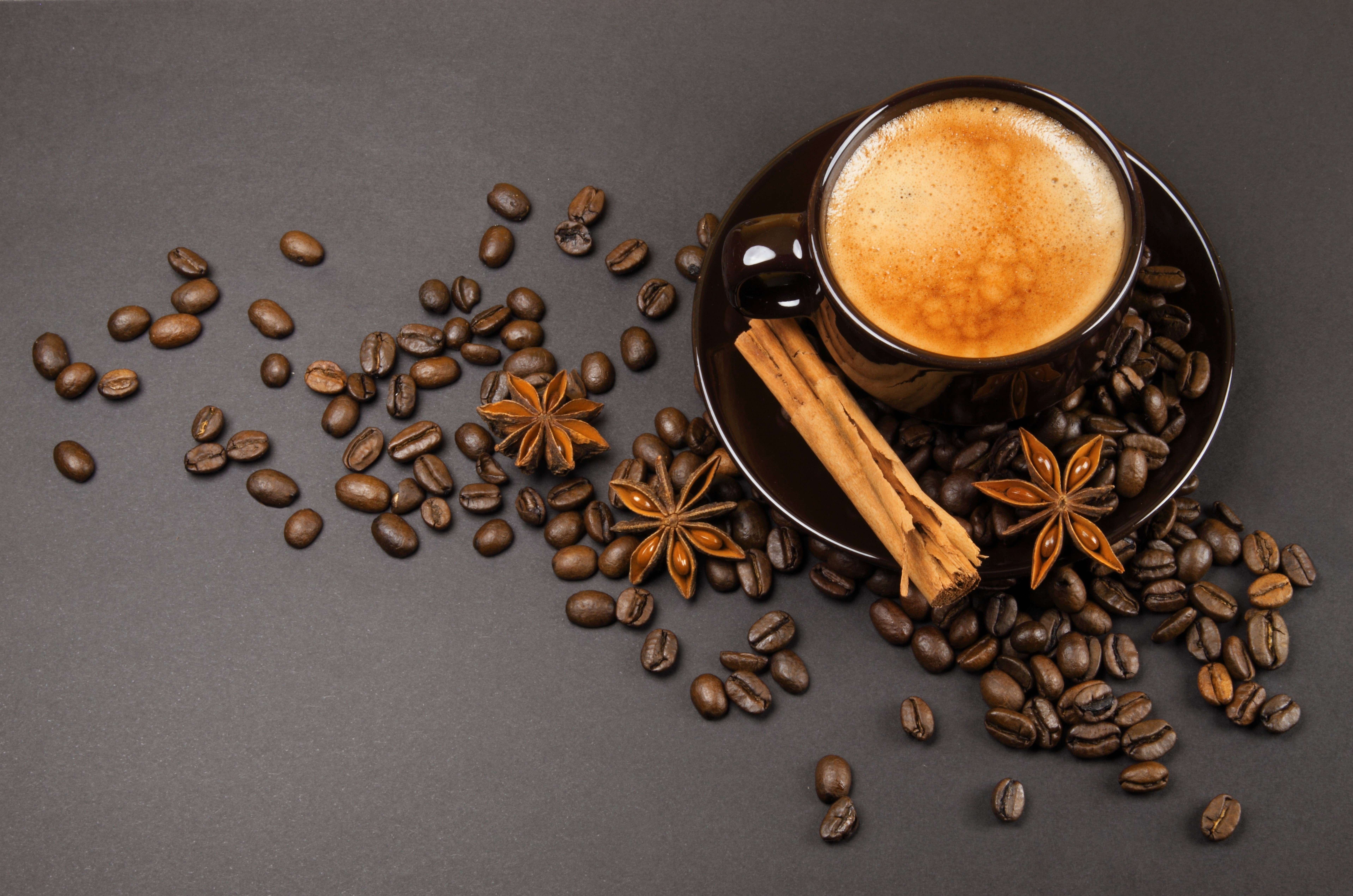 Coffee cup with beans, cinnamon, and star anise HD Wallpaper