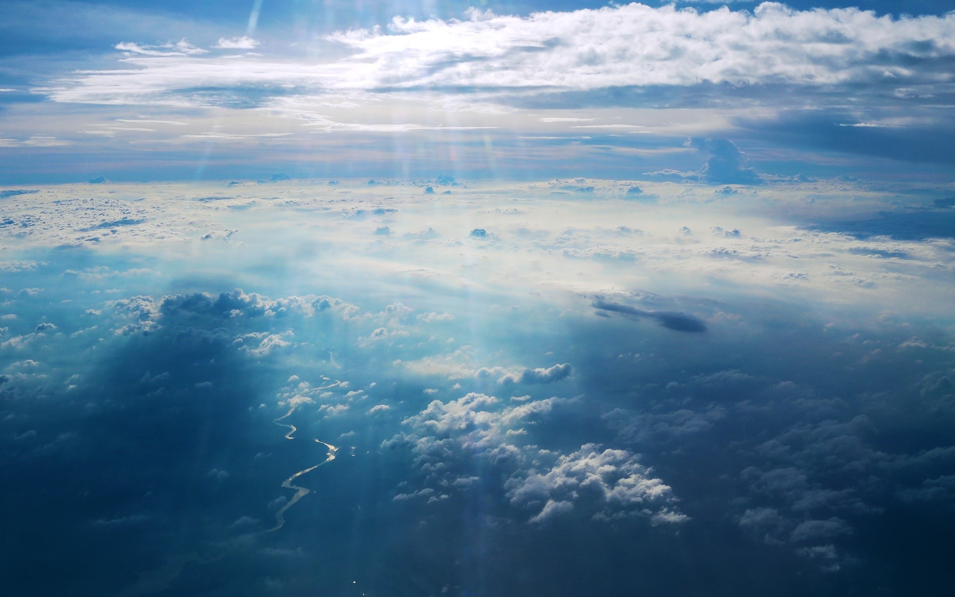Aerial view of clouds and a winding river HD Wallpaper