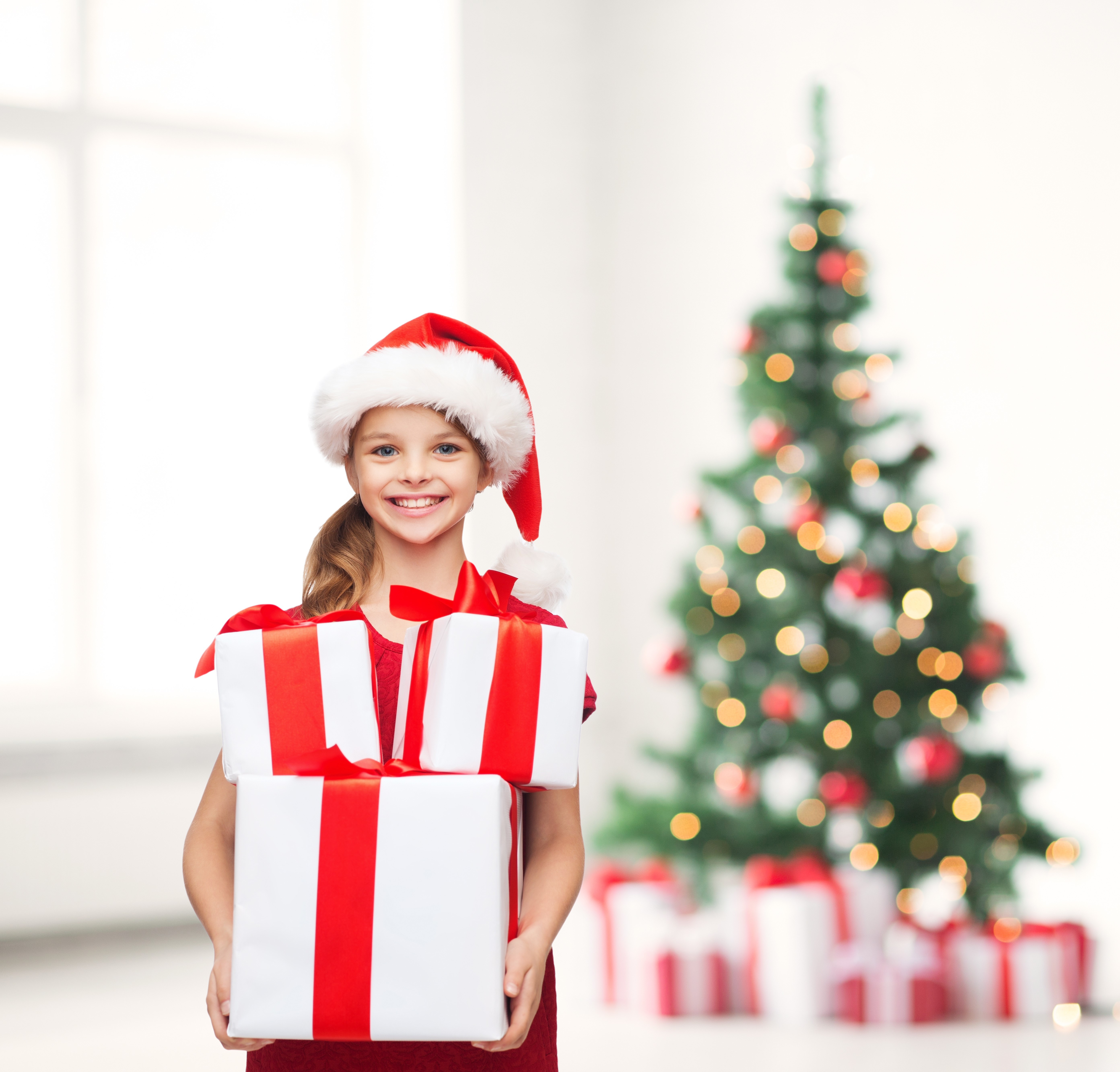 Smiling Girl with Christmas Gifts and Tree 4K HD Wallpaper
