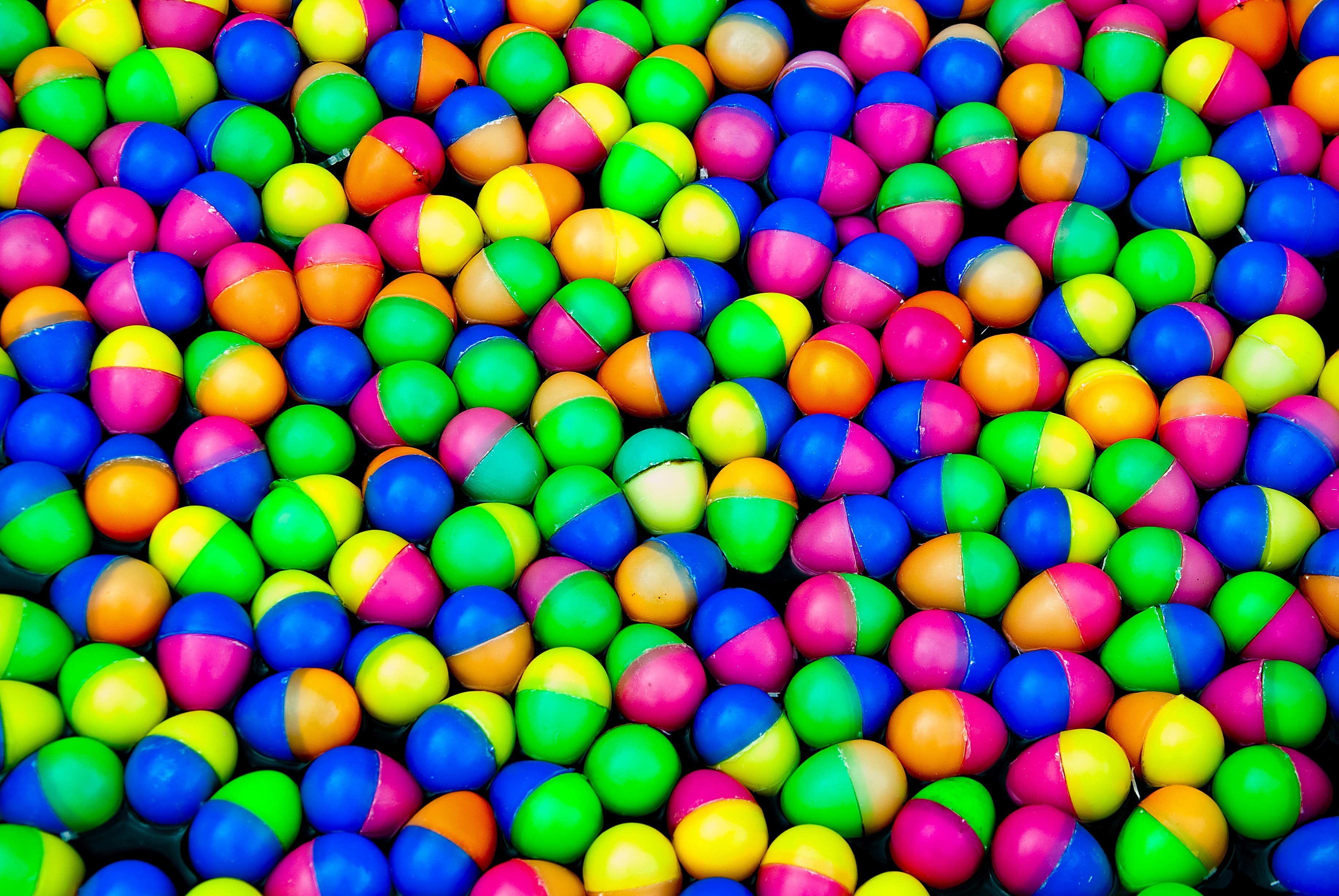 A pile of colorful plastic Easter eggs HD Wallpaper