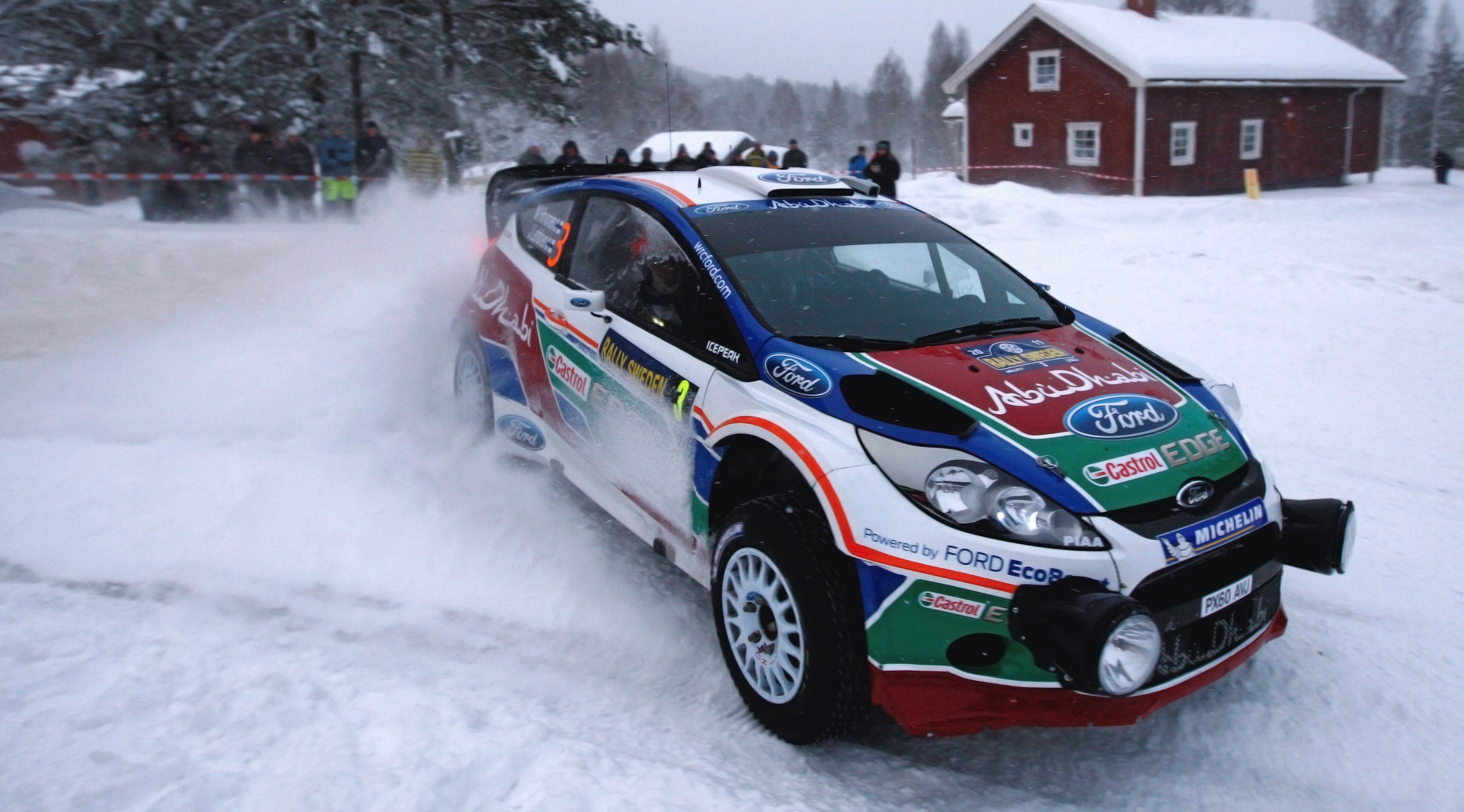 Ford Fiesta rally car driving in snow HD Wallpaper