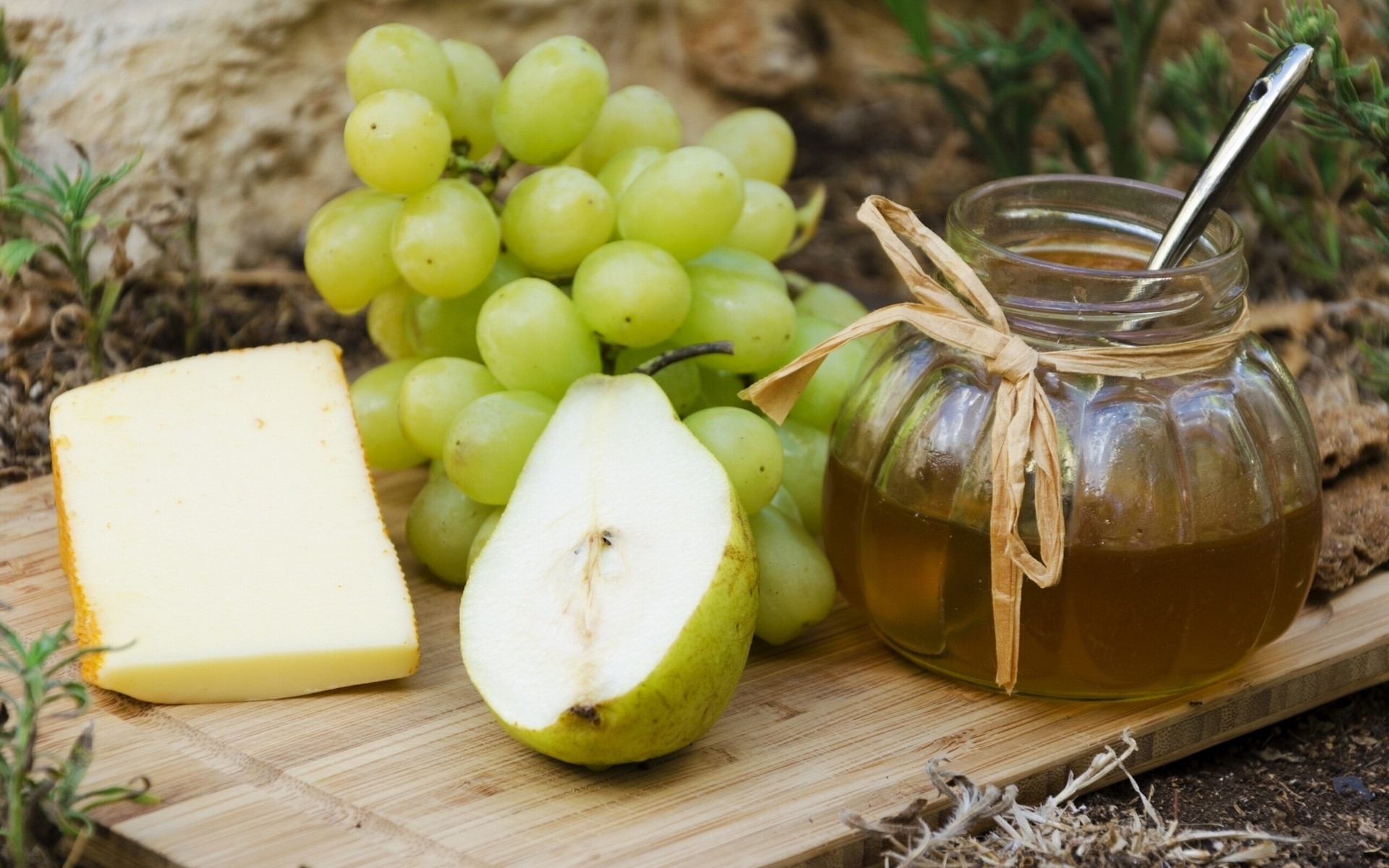 Cheese, grapes, pear, and honey on a wooden board HD Wallpaper