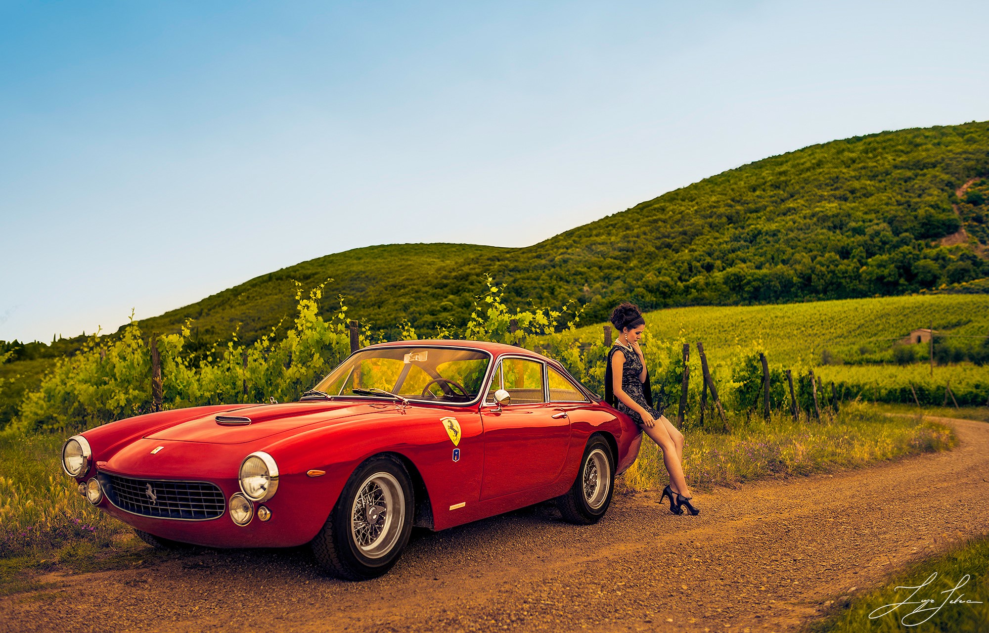 Woman leaning on a red Ferrari 250 GT in a vineyard HD Wallpaper