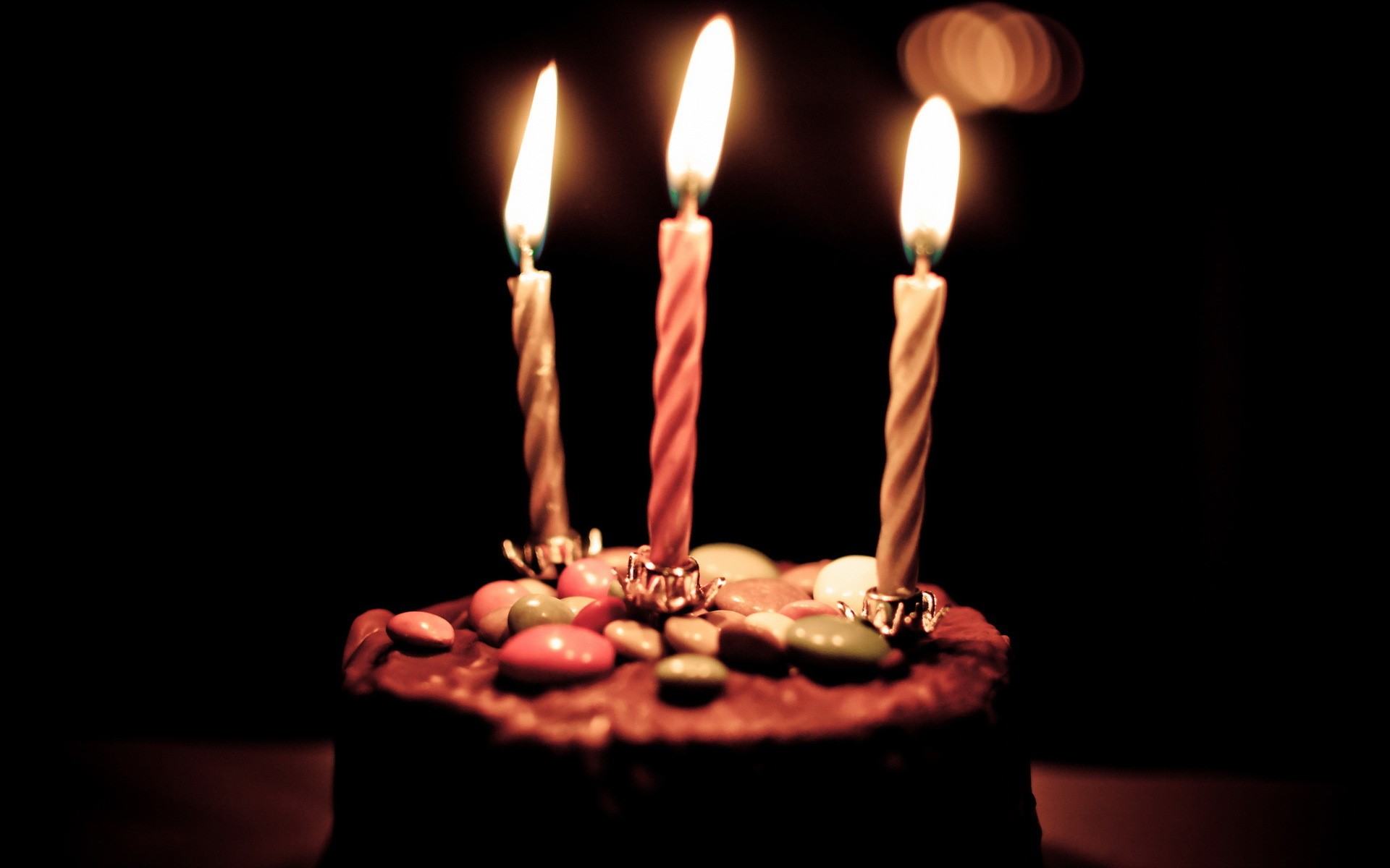 Birthday cake with lit candles and candies HD Wallpaper