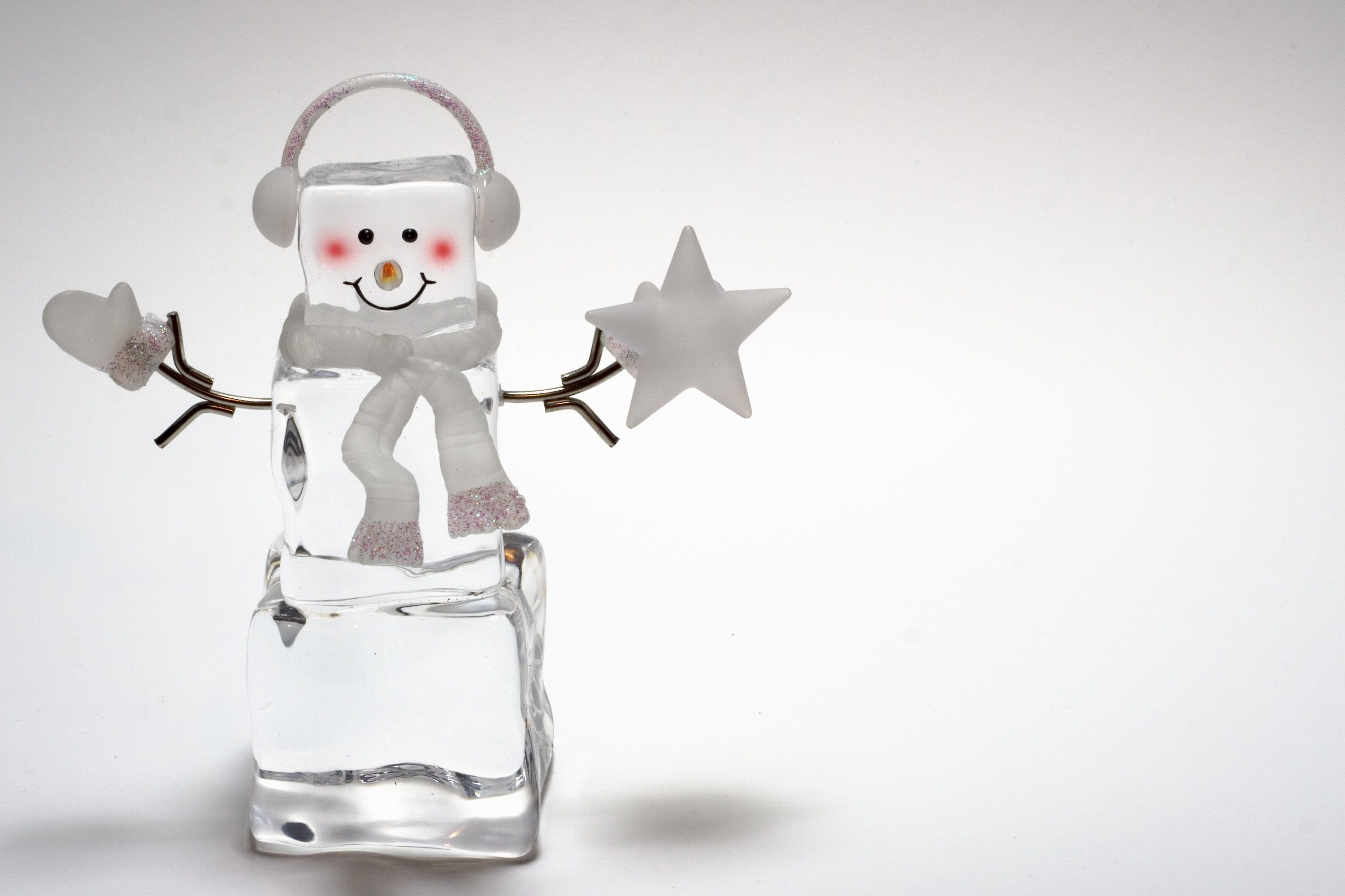 Ice snowman with headphones and scarf holding a star HD Wallpaper