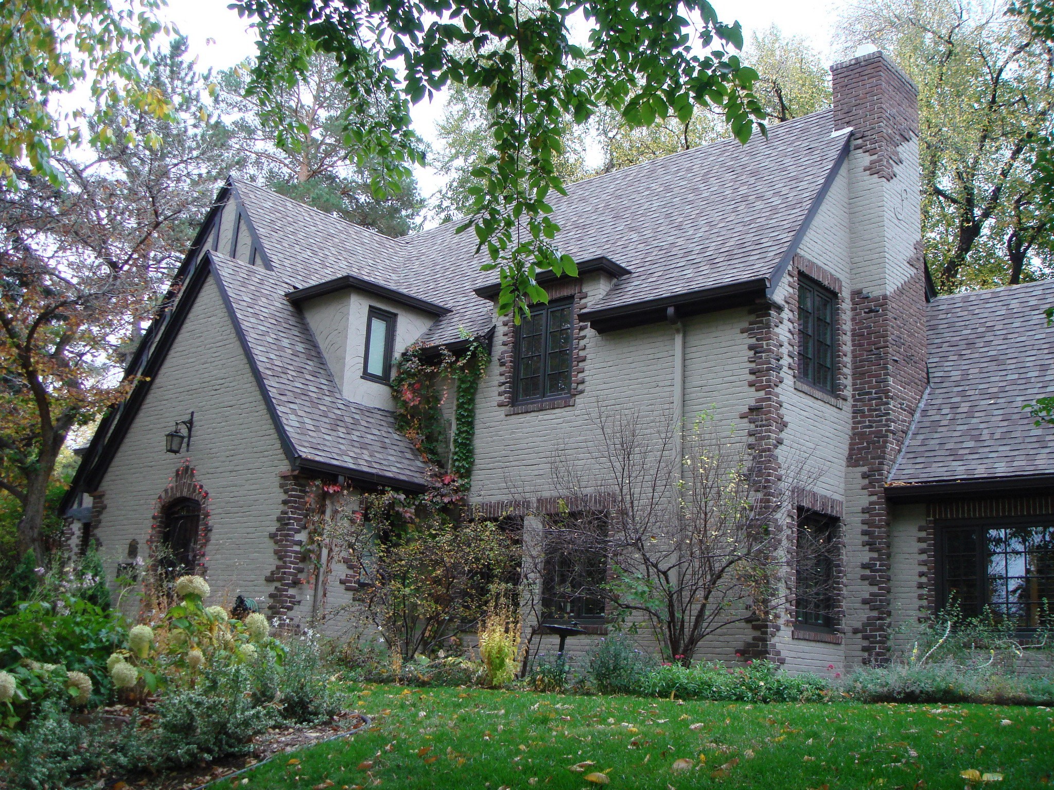Brick house with dormer windows and chimney HD Wallpaper